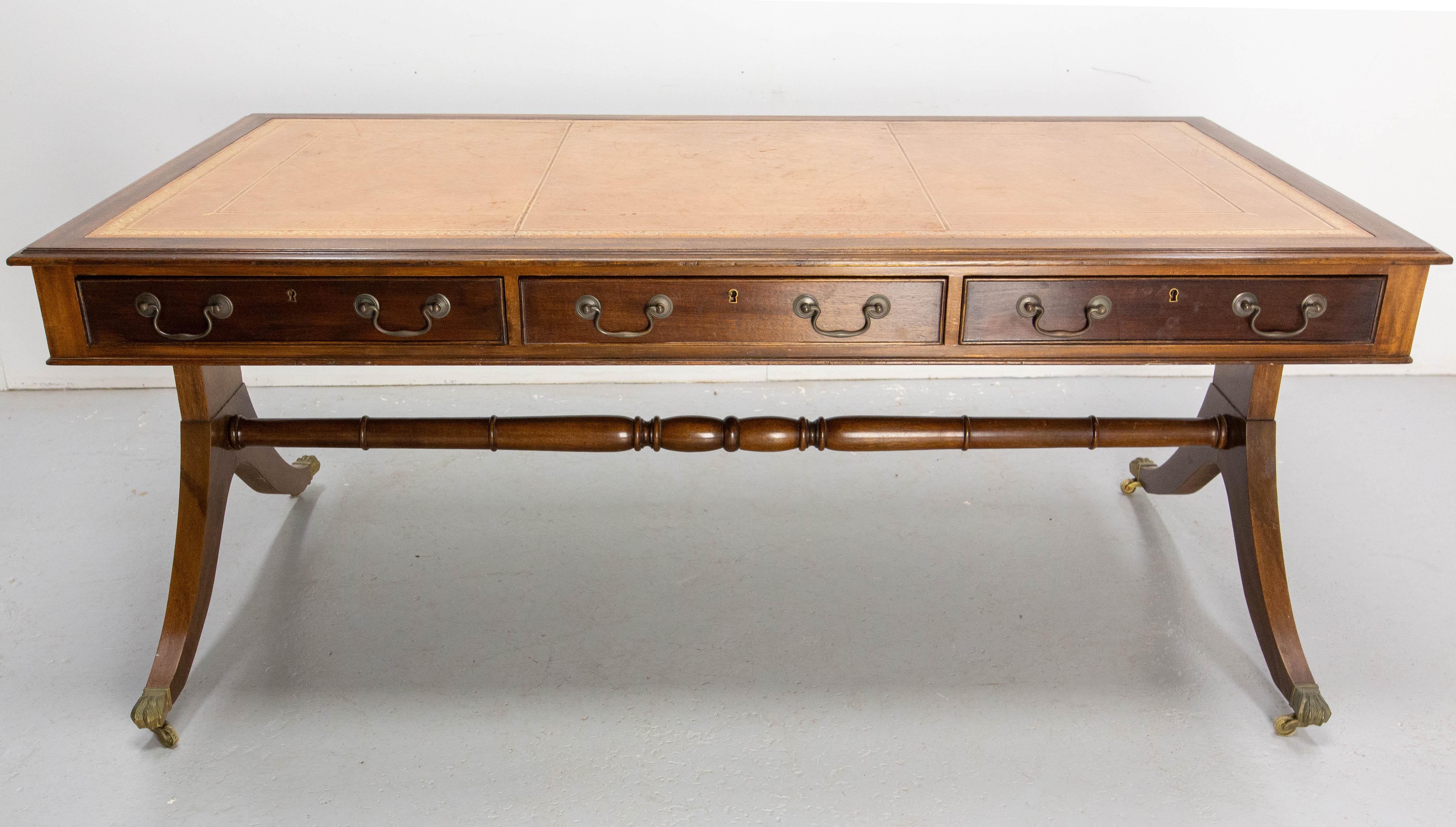 English large desk or side table, circa 1900.
The top is recovered of a large piece of laether.
Three drawers on each side. Two keys will be added. 
The lion paws are made of bronze and conceal wheels.

This double desk, as its name suggests, can be