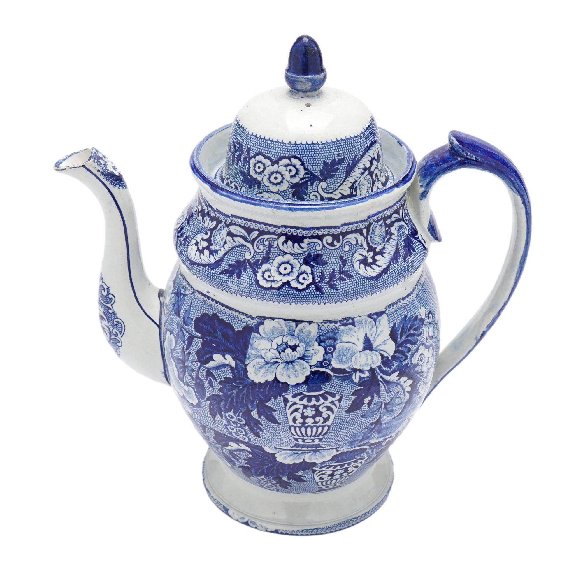 Historic Blue transfer decorated pyriform ceramic coffee pot with domed lid. The transfer cobalt blue decoration is applied in floral bands on the lid, shoulder of the pot, and the body of the pot. The applied handle is cobalt blue repeated on the