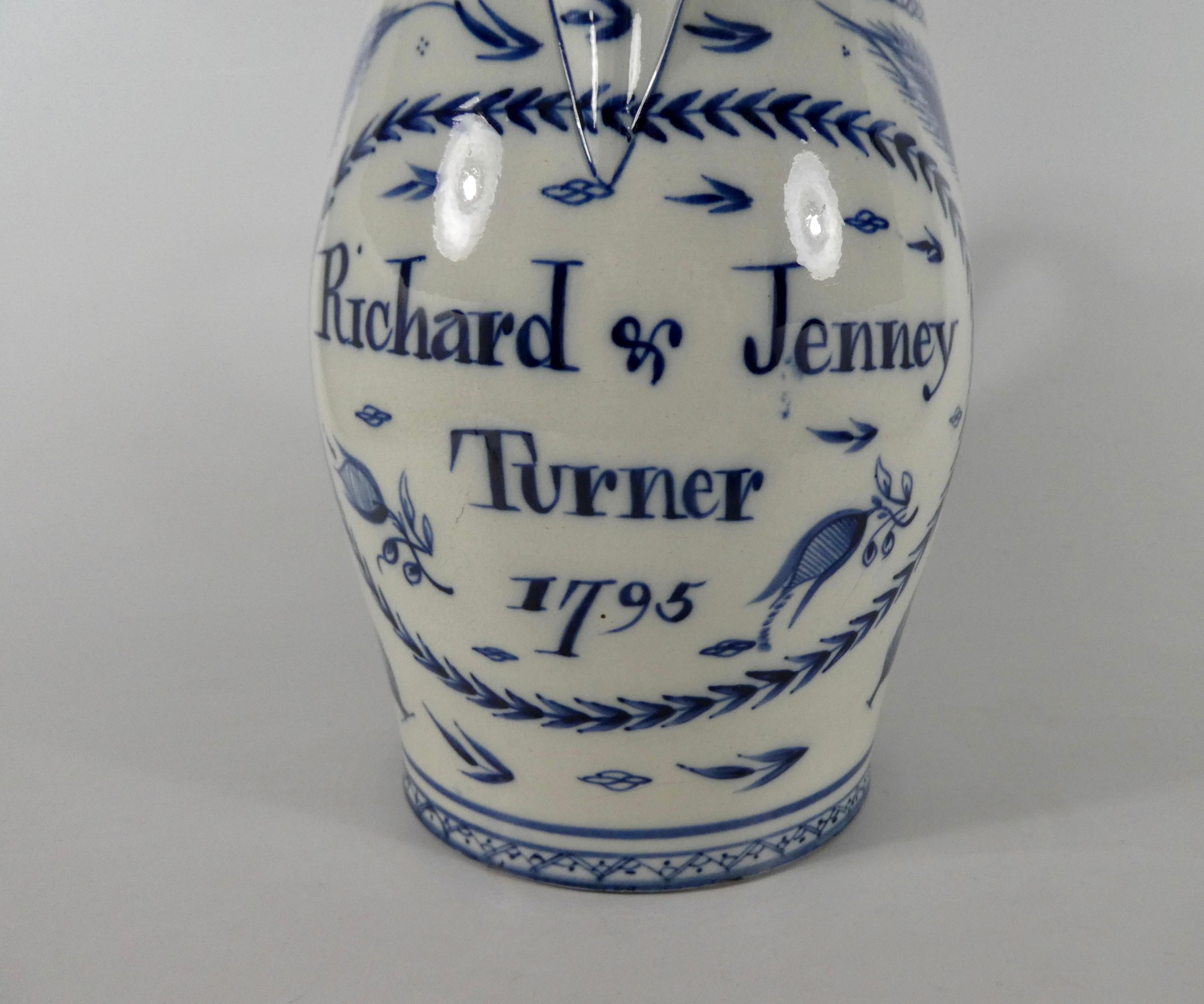 Liverpool pottery pearlware jug, dated 1795. Hand painted in underglaze blue, with an inscription ‘Richard & Jenney Turner, 1795’, within a laurel wreath cartouche. Either side painted with elaborate sprays of flowers, beneath a chevron border. The