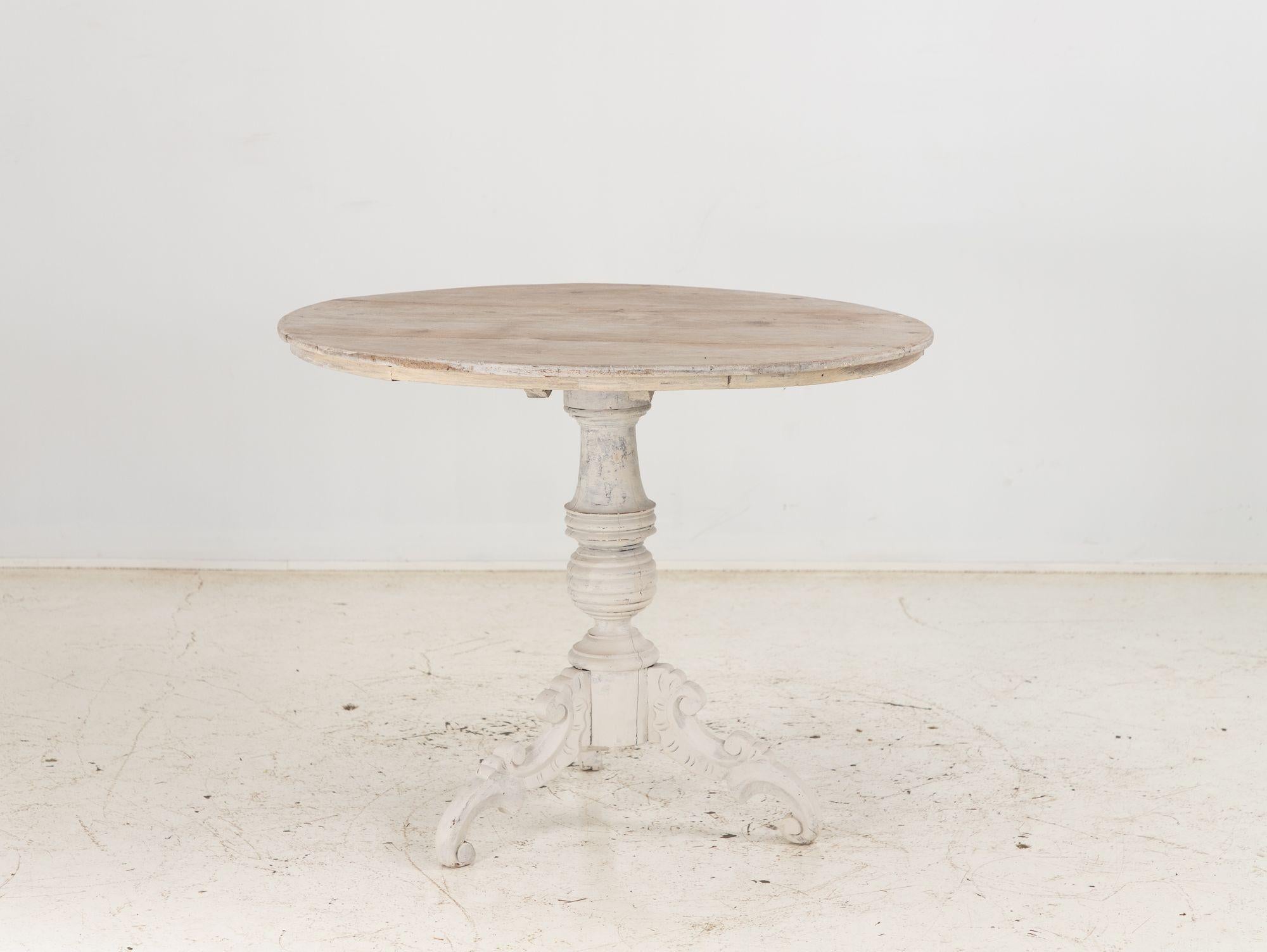 The English late 19th-century pedestal table, elegantly painted in gray, exudes timeless charm and sophistication. Crafted with meticulous attention to detail, this table features a central pedestal base that provides visual appeal. The gray paint