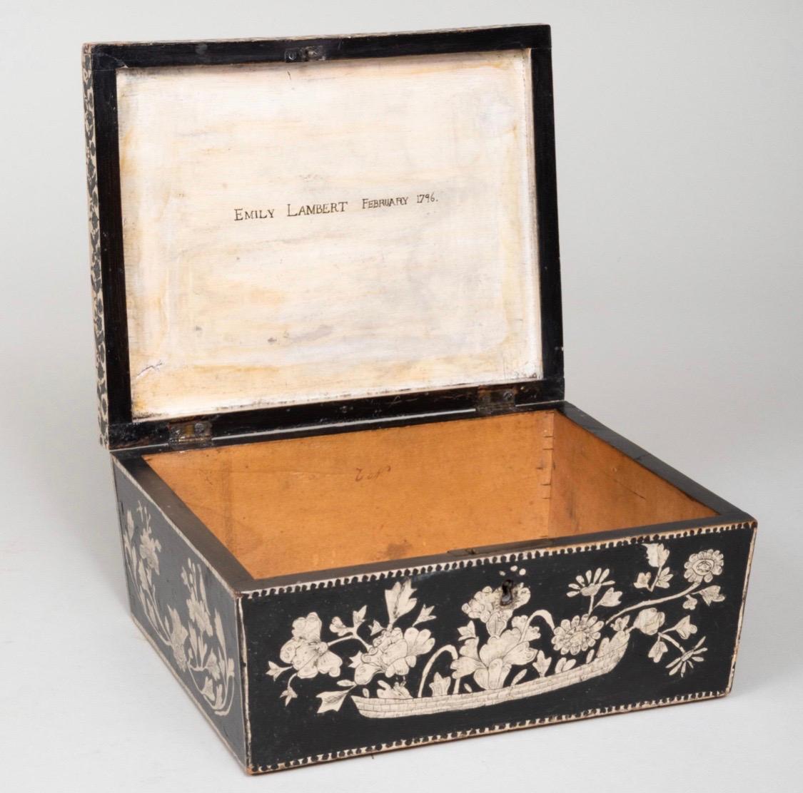 English penwork box
Wooden box handpainted in a handsome black with white floral design and decoration.
The interior of the cover signed and dated 'Emily Lambert February 1796'. This box is the period of Jane Austen. One can imagine Emily Lambert