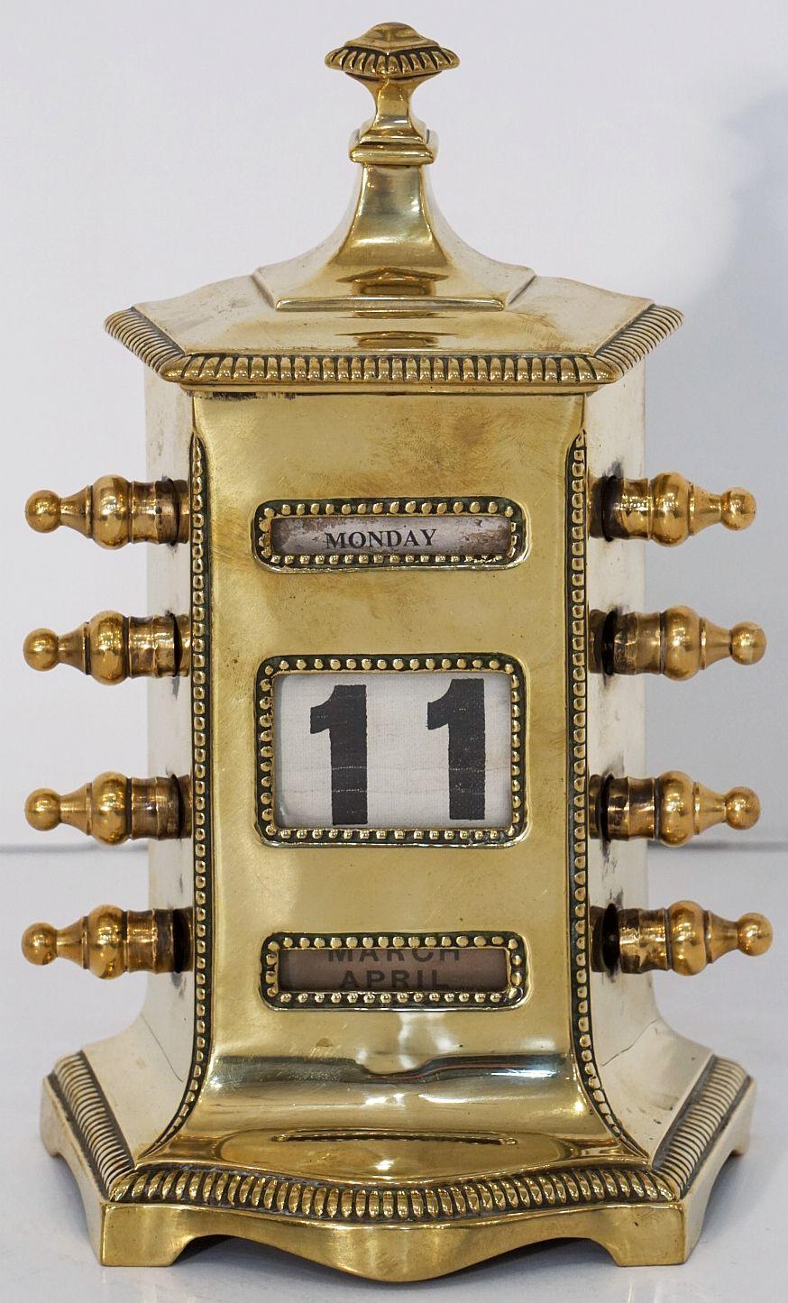A handsome English perpetual desk calendar of cast brass by the celebrated brass foundry maker William Tonks and Sons. Featuring a stepped top with a decorative beaded edge, flared sides and front with matching design, three view windows to the