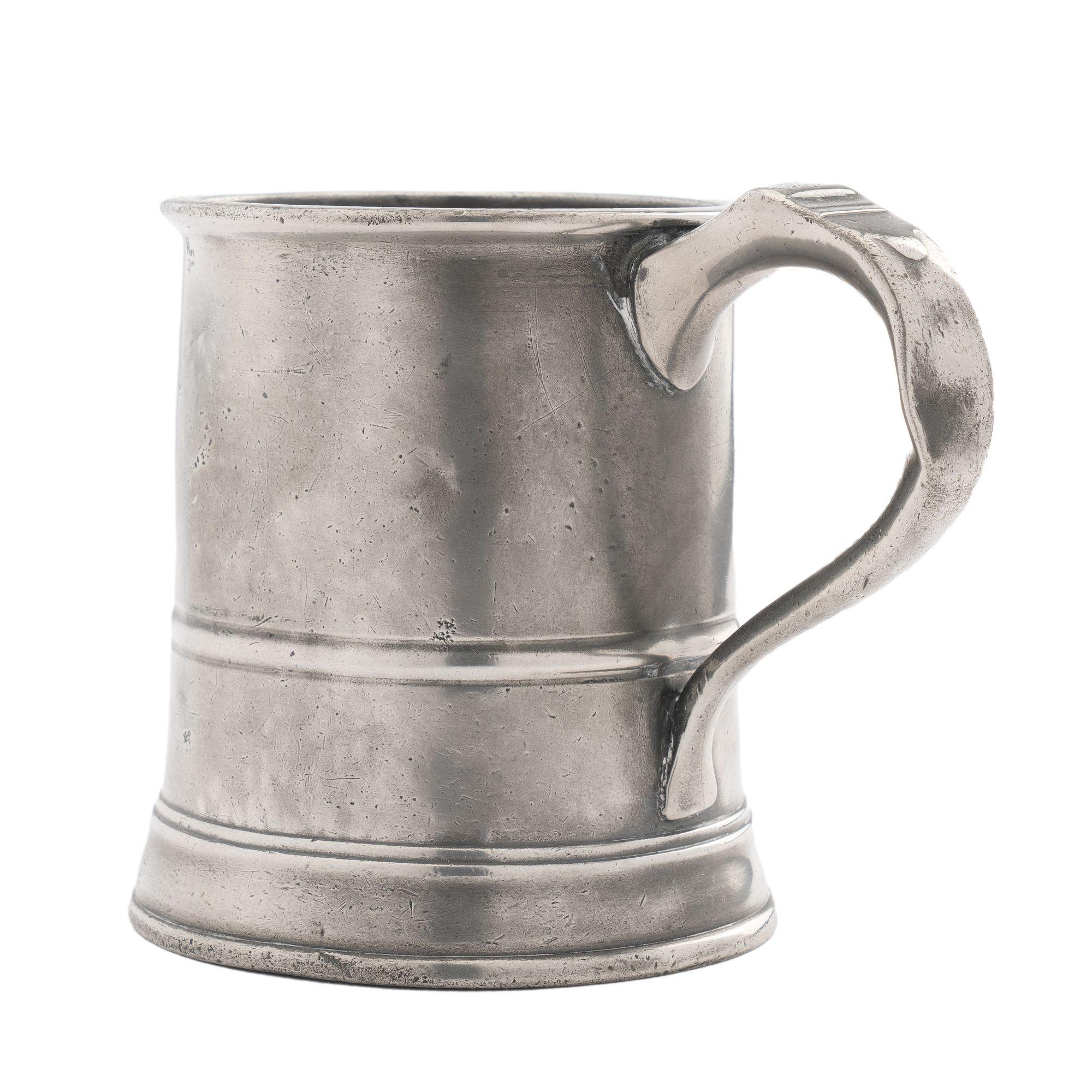 One pint English pewter mug with beaded rim and bead at 2/3s from rim repeated at the ogee base molding. Applied hallow cast loop handle.
England, mid 1800s.