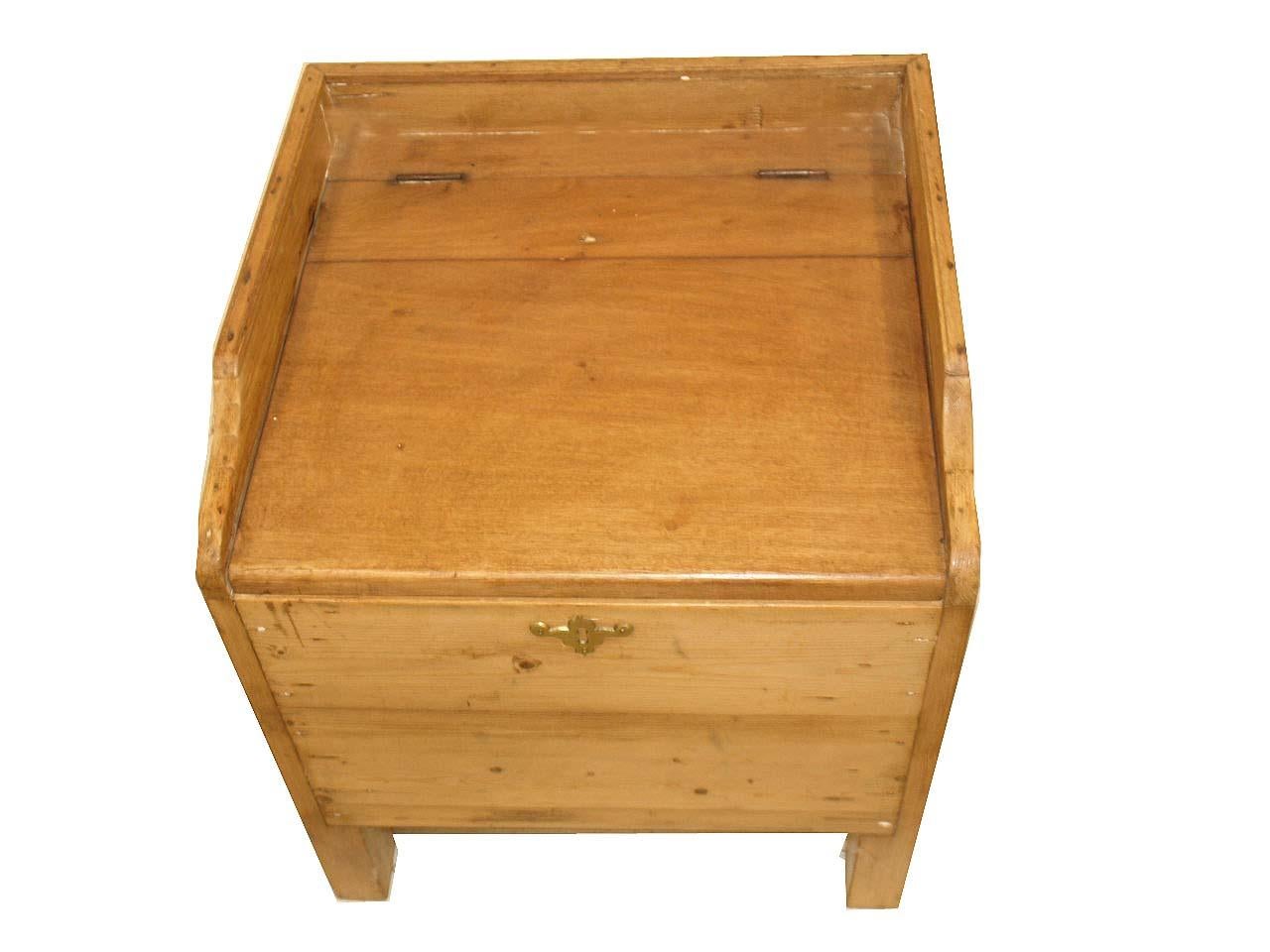 English pine end table, originally was a commode, the top is faded mahogany and lifts ( inside there is a hole , per photo, where the porcelain potty would have sat.) There is a gallery around the top ; the sides have carrying pulls. The table rests