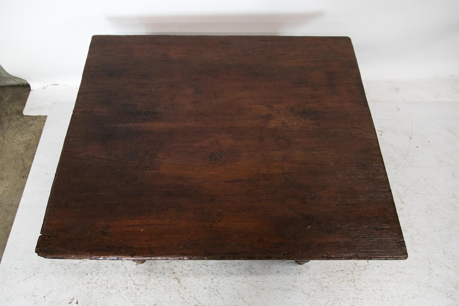 This pine coffee table has been lowered from its original height to a contemporary coffee table height. The table has evidence of old insect activity. The sides have double peg construction. The dovetailed and beveled support cleats are original.
  