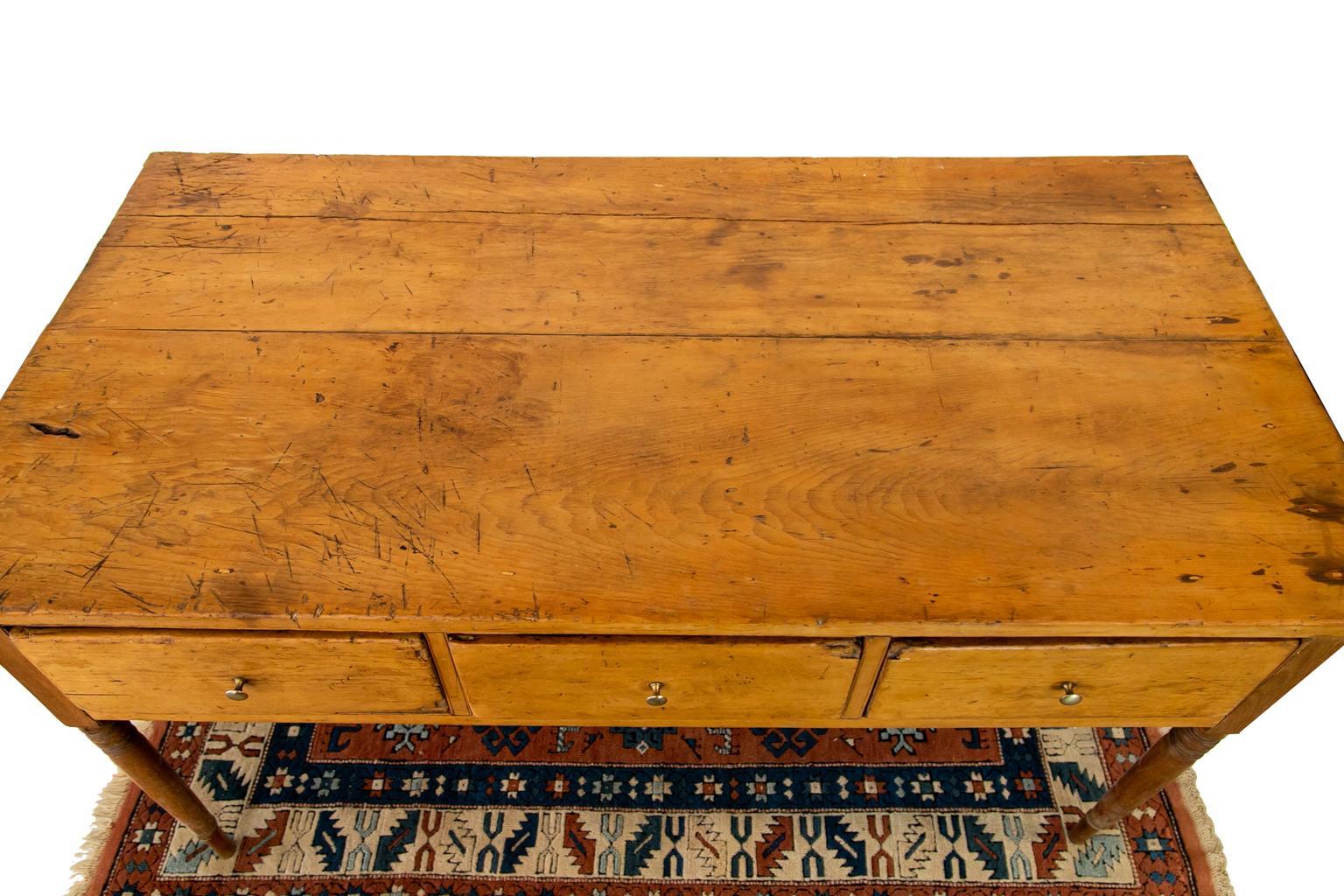 The top of this console table has shrinkage separations and multiple scaring on the top surface patina.
