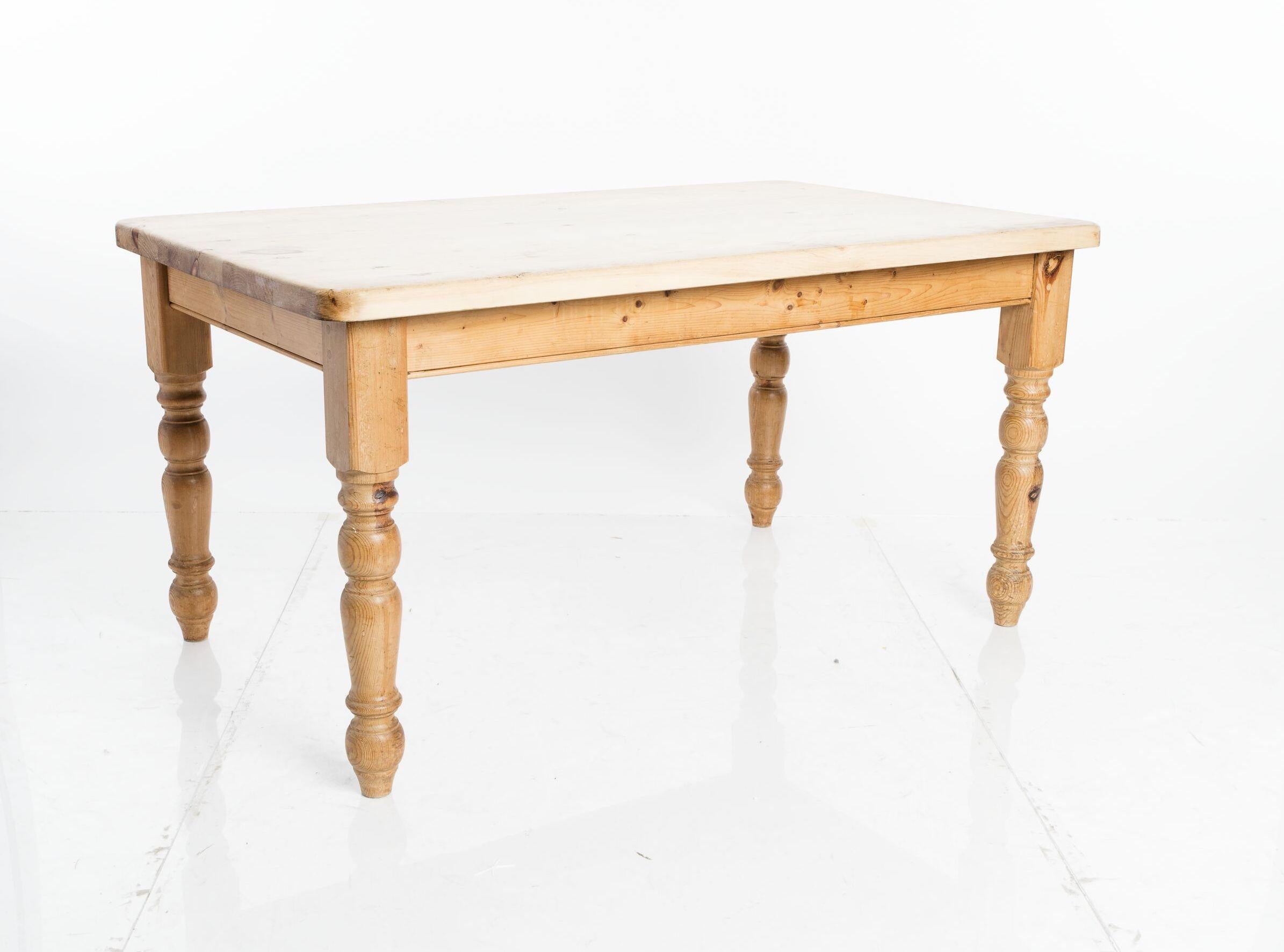 English pine dining table, circa 1880. A beautifully maintained knotty pine top.