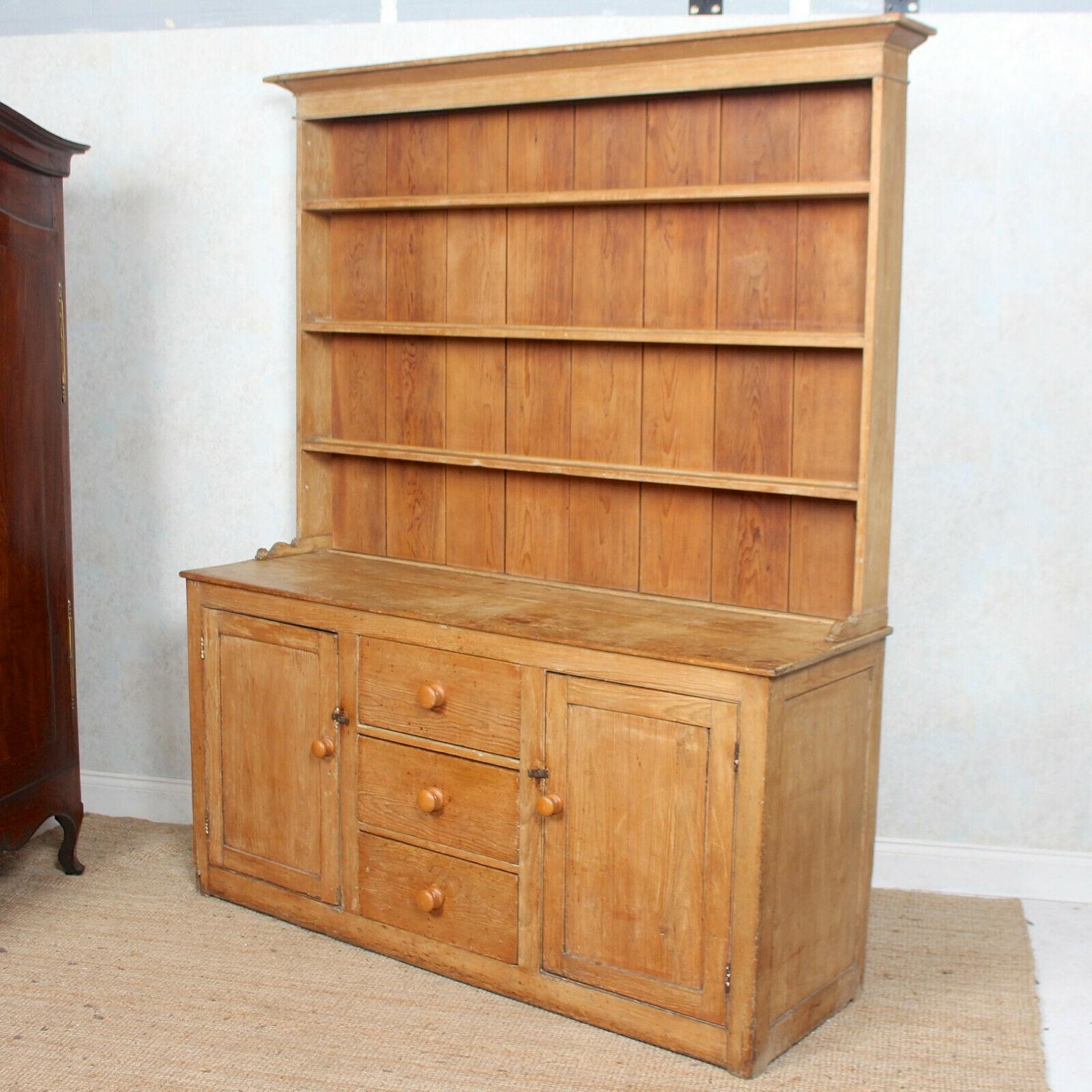 An impressive 19th century pine dresser.
The upper section with broad cornice, paneled back and shelving. The base fitted three central drawers flanked by paneled doors enclosed shelving and raised on a plinth base.
Dismantles to two sections for