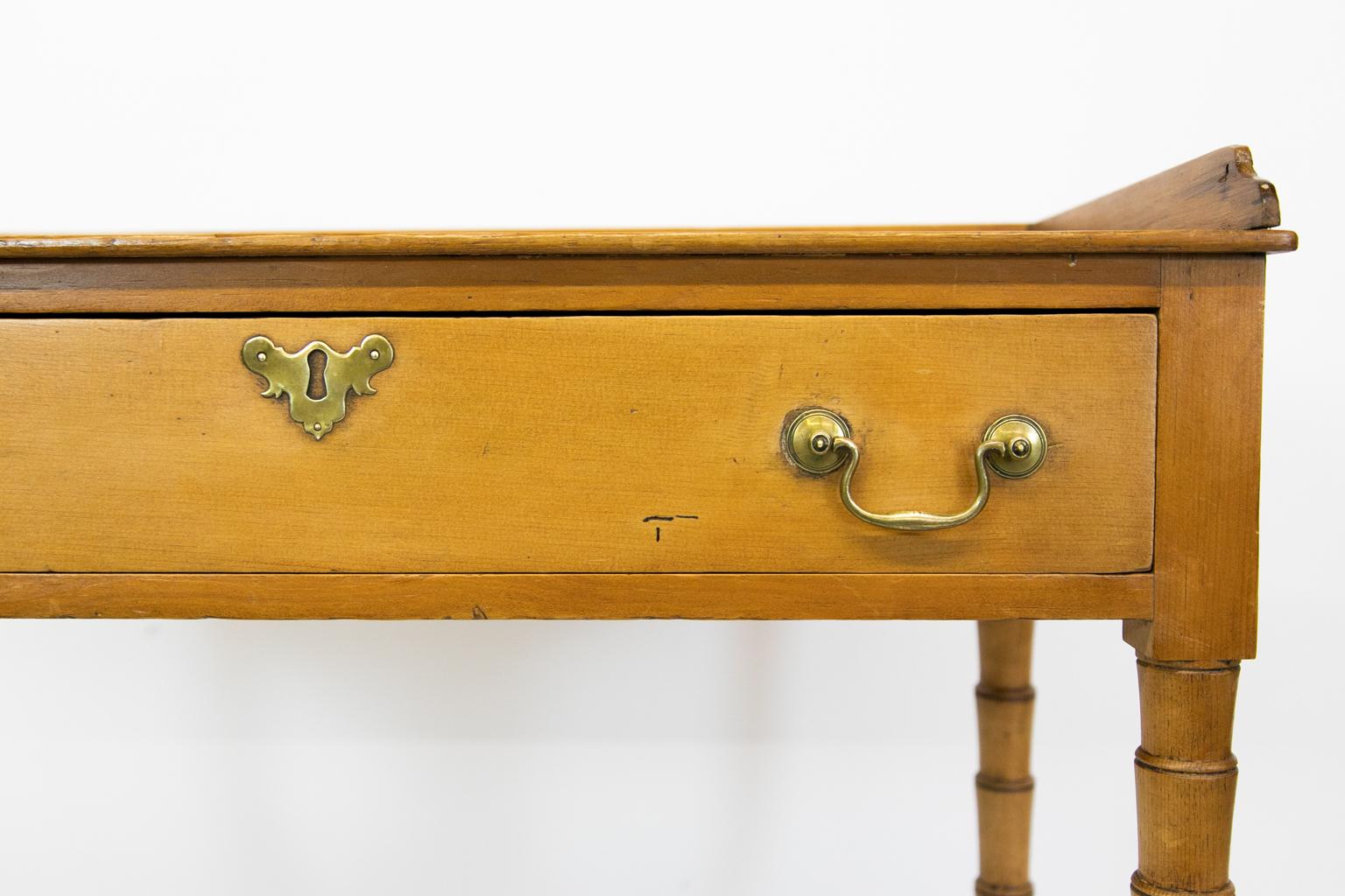 English pine one-drawer faux bamboo table has a gallery with shaped front edges.