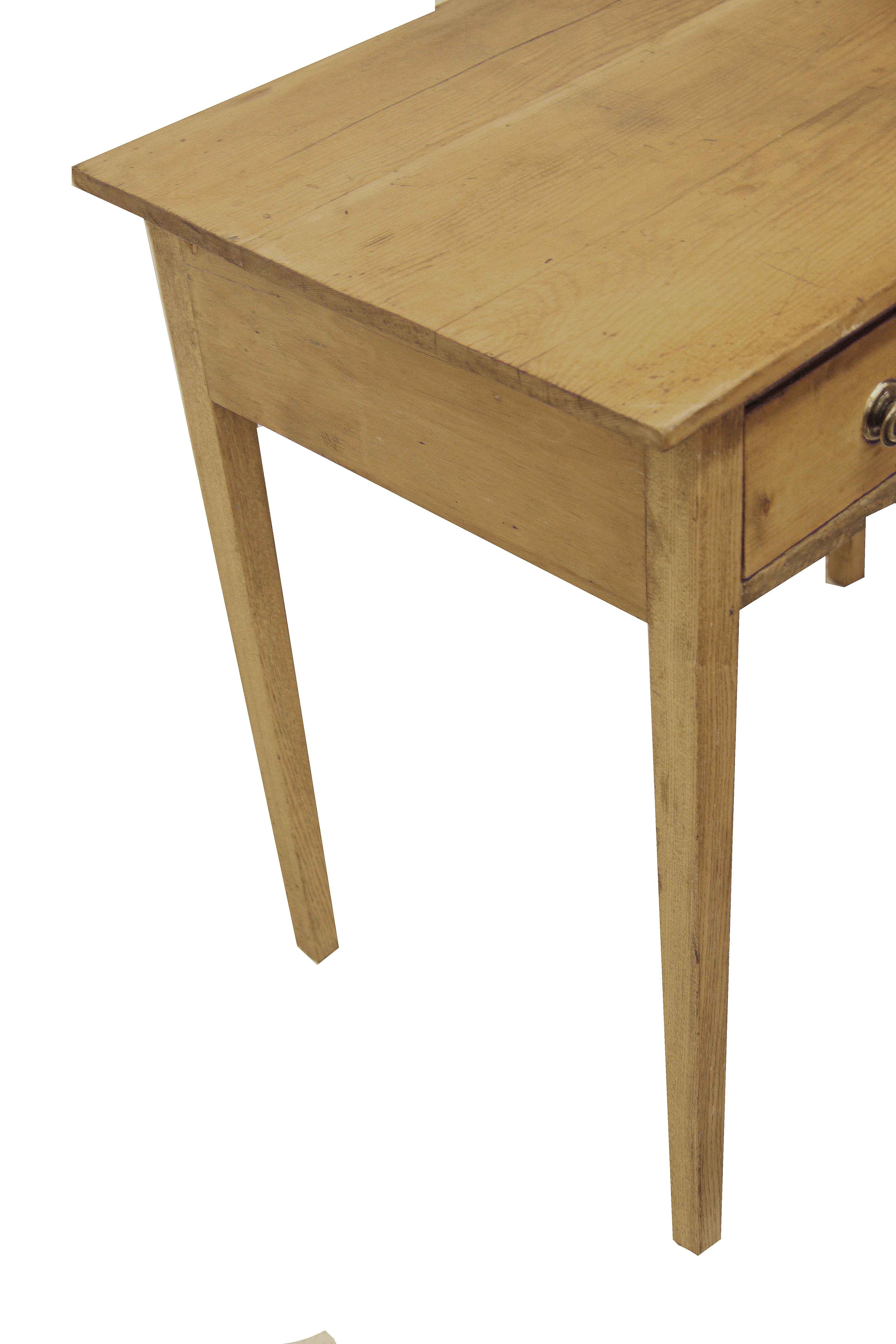 English pine one drawer side table,  this table has a wax finish with nice color and patina.  The single drawer retains the original brass knobs,  it has a small repair on the right hand lower corner of the drawer ( see photo)  The legs are nicely