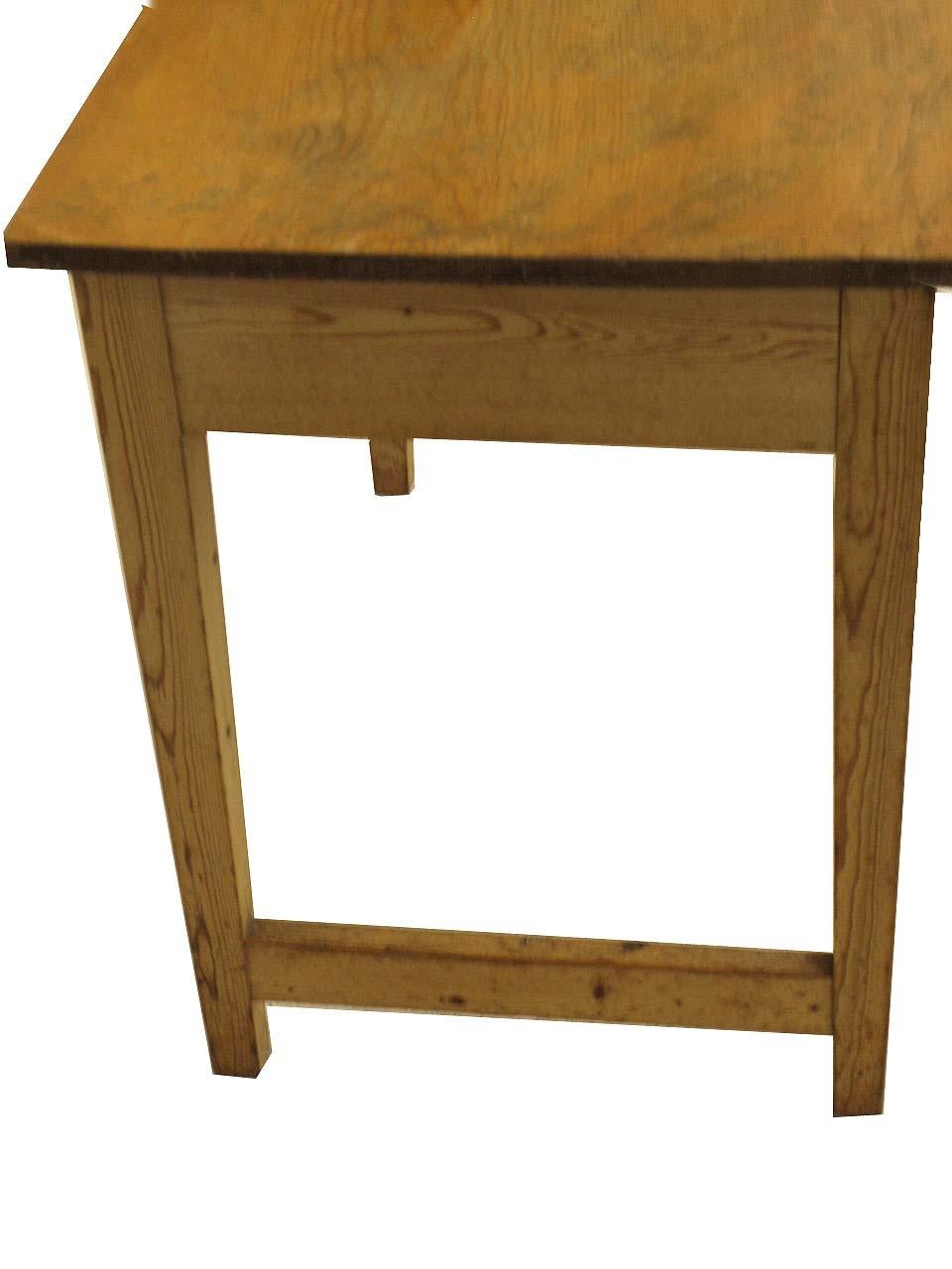 English pine one drawer writing table which was most likely painted originally and stripped and wax finished in the last 30 years. It has a pleasant patina , has 24'' of clearance for seating and a drawer at the end for storage. With stretchers on