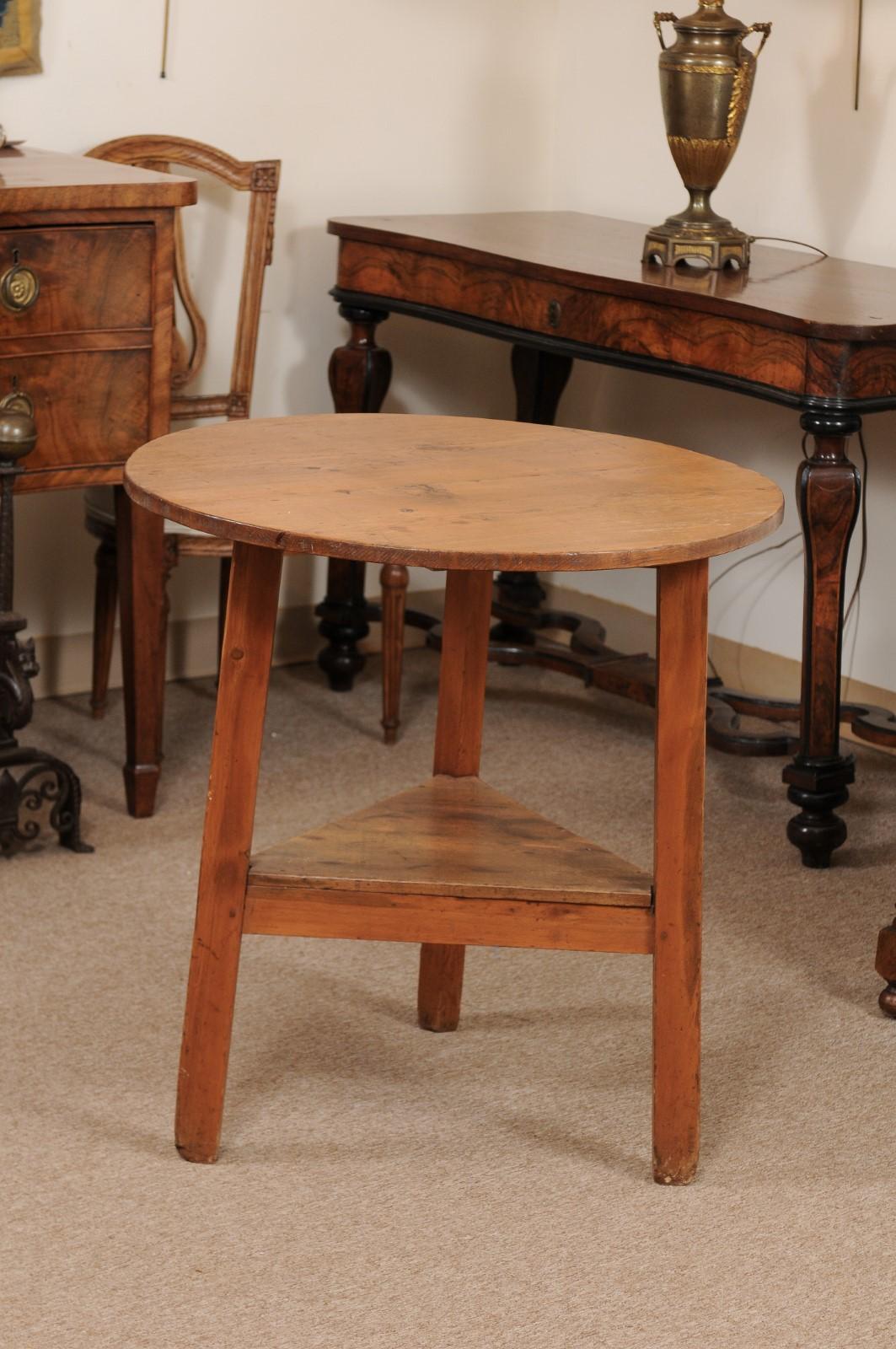 19th century English Pine cricket table with round top, lower triangular shelf joined by 3 legs.