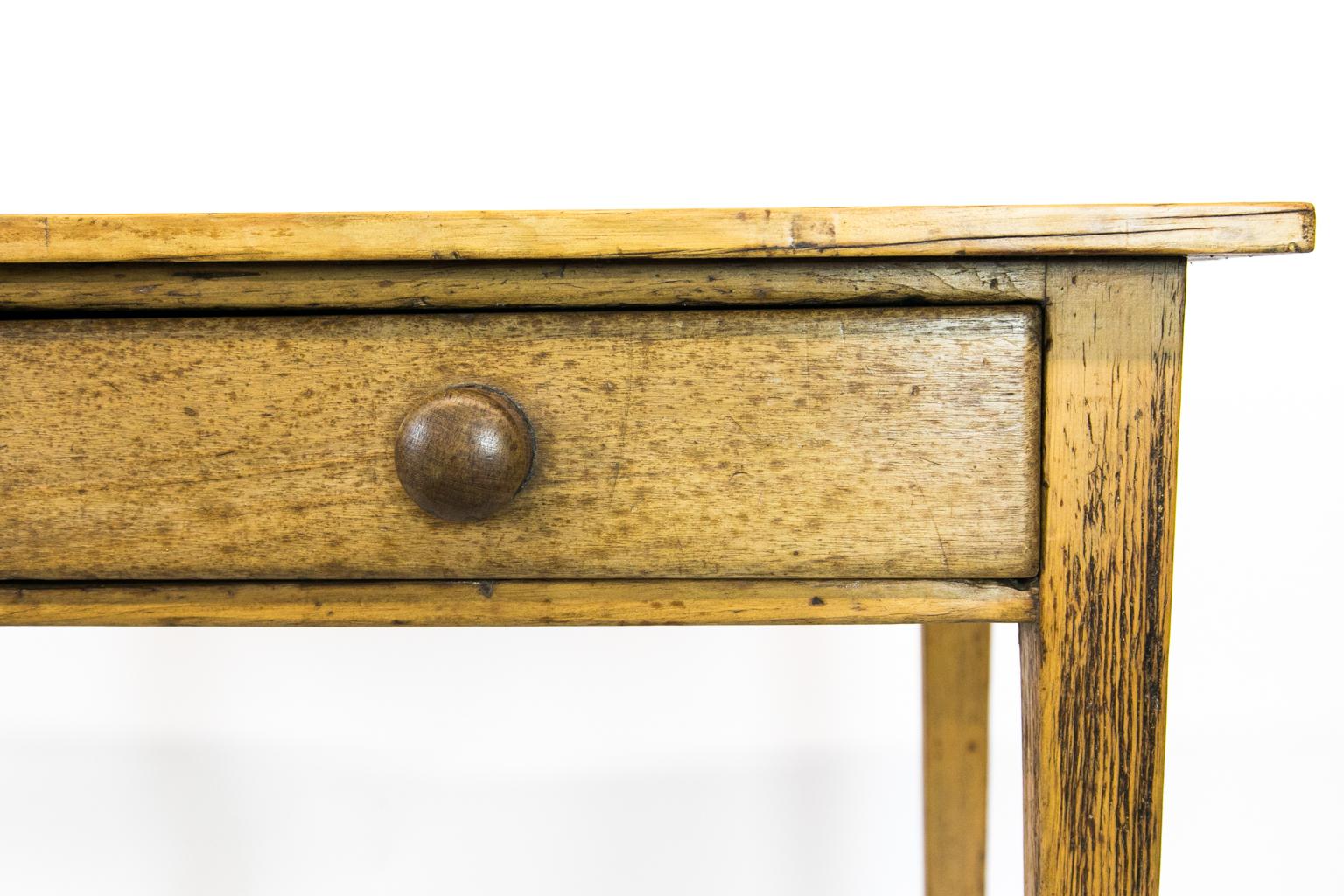 English pine two-drawer stretcher table has its original wooden knobs.
  