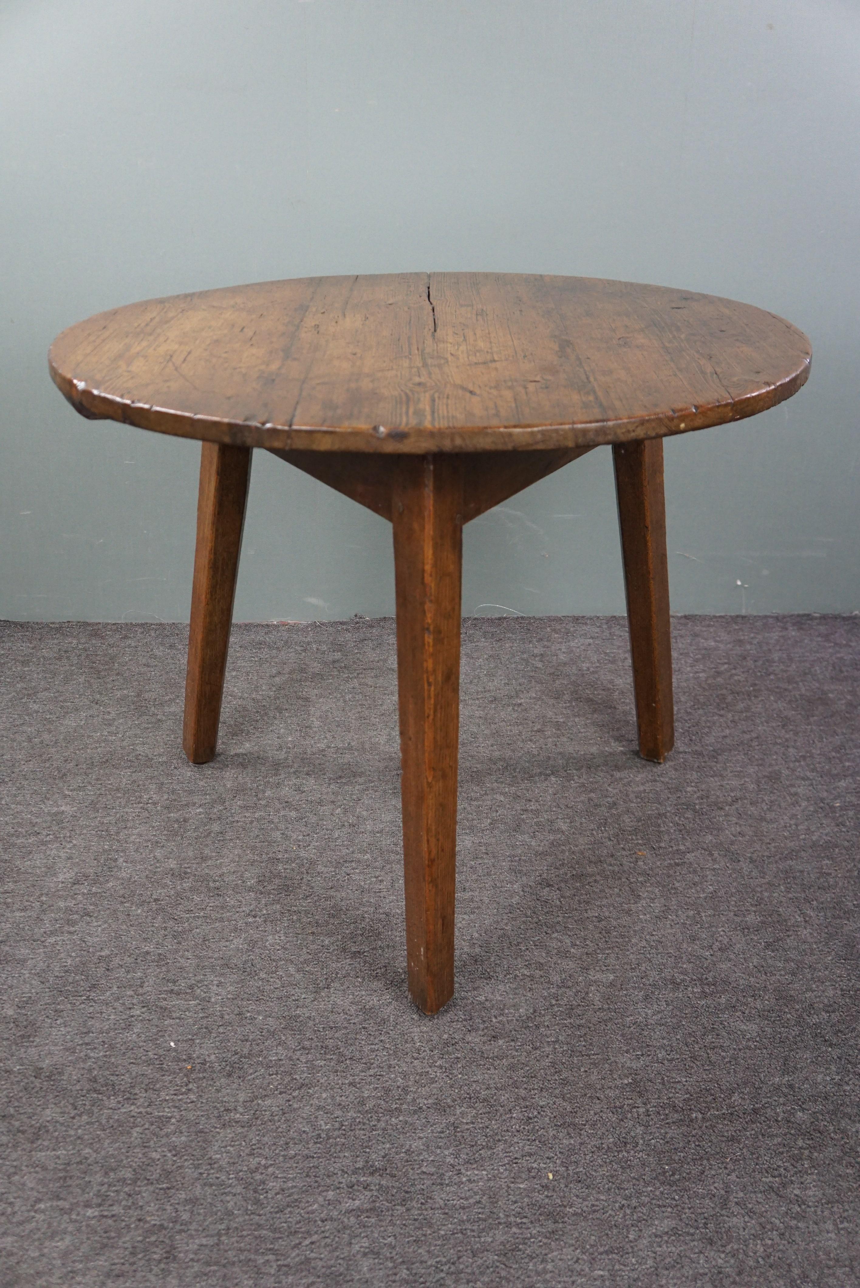 Offered is this beautiful English pinewood Cricket table from the 18th century. If you're a true enthusiast of beautifully styled interiors, you simply cannot overlook genuine antique English Cricket tables. The purity and class these tables exude