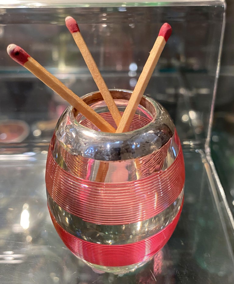 A beautiful English ovoid match striker (or match strike vesta) of striated pink glass, topped with sterling silver.

Hallmarks for sterling silver.
