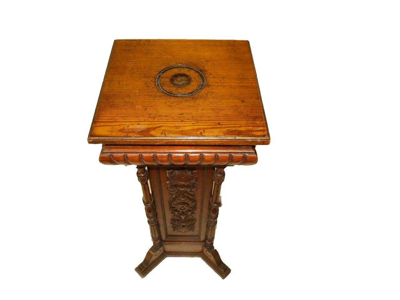 English ''pitch'' pine carved pedestal, this four sided piece has a plain top with engraved circle above a gadrooned frieze, supported by turned balusters at each corner, the square shaft has intricate and detailed carving in relief, the pedestal