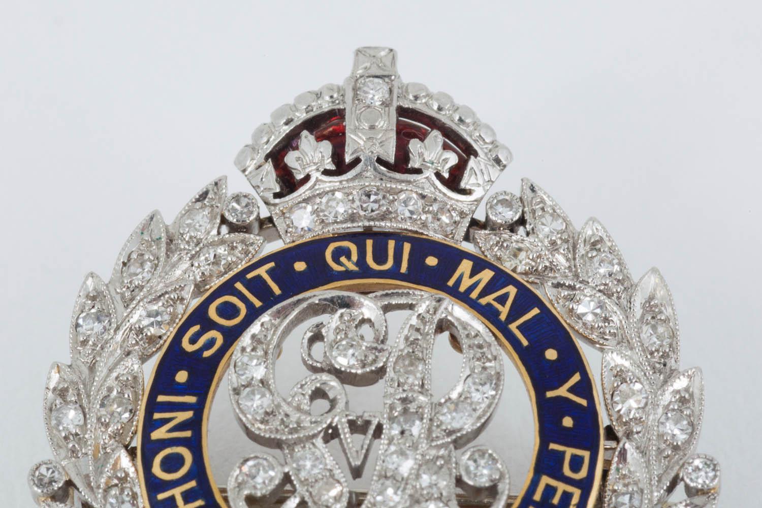 A finely made, period, blue enamel and diamond set brooch in the form of the Royal Engineers,red enamel crown.English c 1920