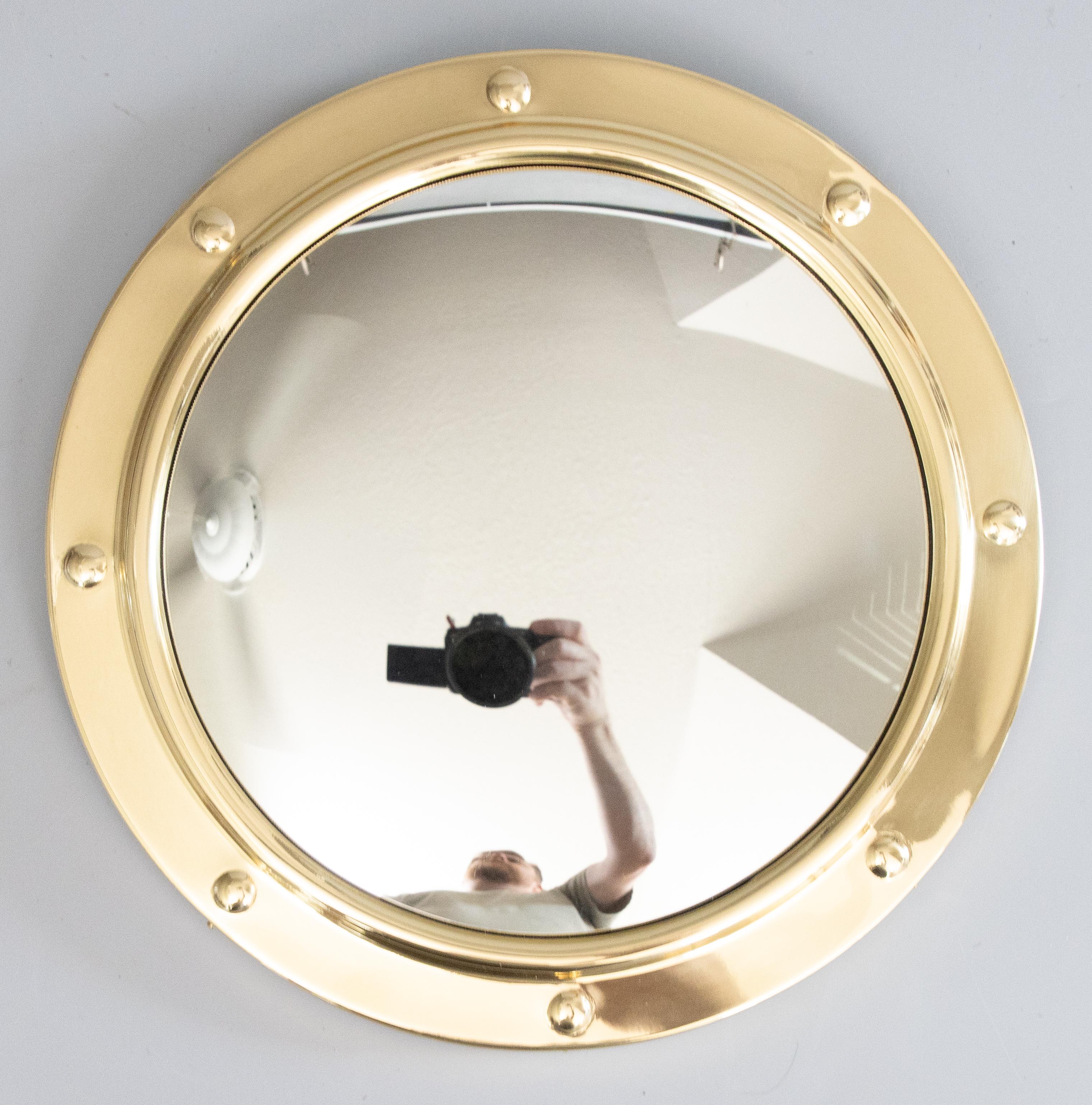 Un elegante specchio nautico d'epoca in ottone lucido, circa 1950. È stato lucidato professionalmente e conserva il vetro convesso originale dello specchio. Uno specchio da parete perfetto per qualsiasi stanza! 

Dimensioni
12ʺW × 1,25ʺD × 12ʺH