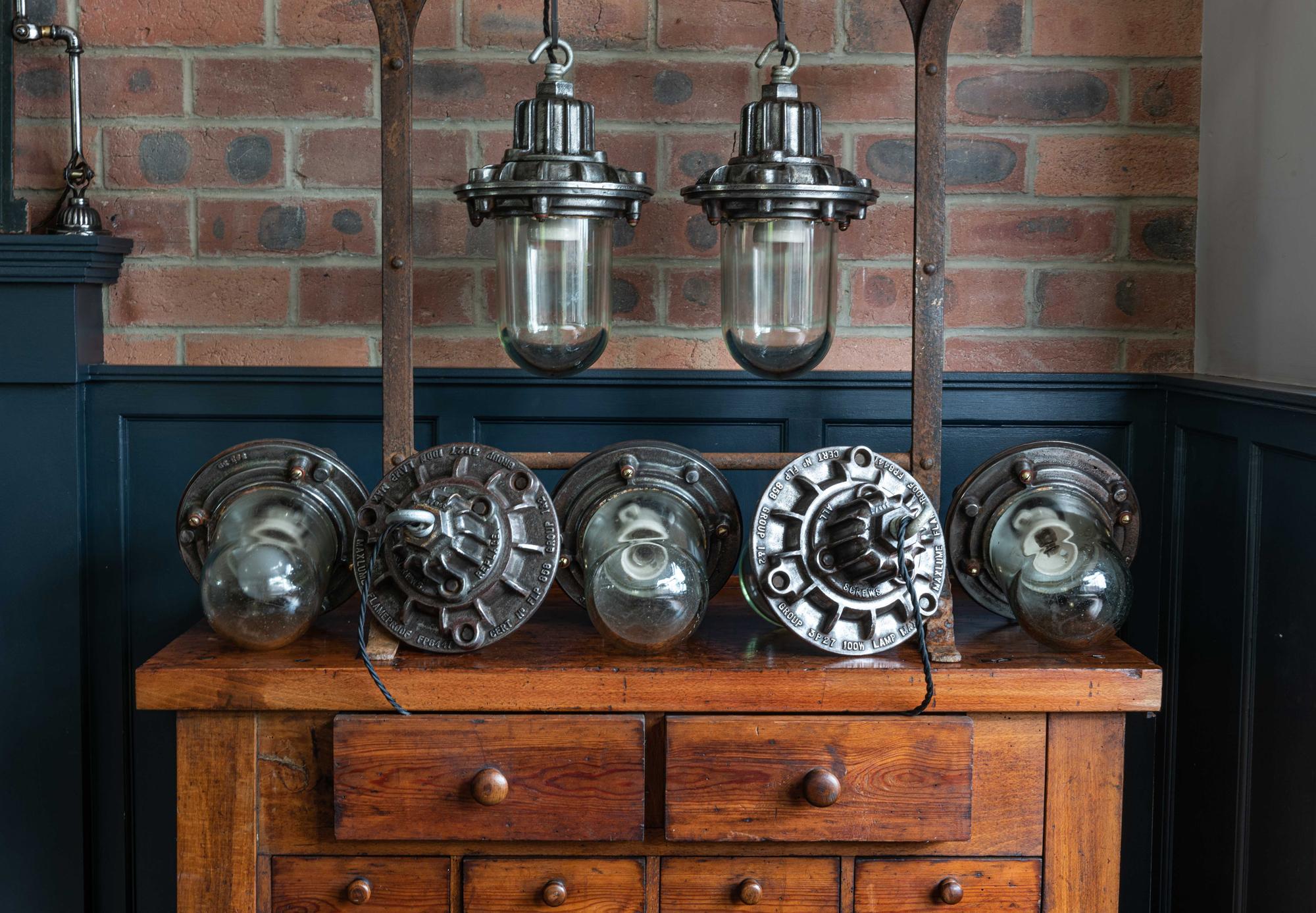 English polished cast iron Factory 'Maxlume' flameproof pendants, circa 1950.
Lightly polished cast iron with thick glass dome shades and original ceramic bulb holders.
Rewired with 2m of 3 core black flex.

Measures: Height 40, diameter 20 cm.