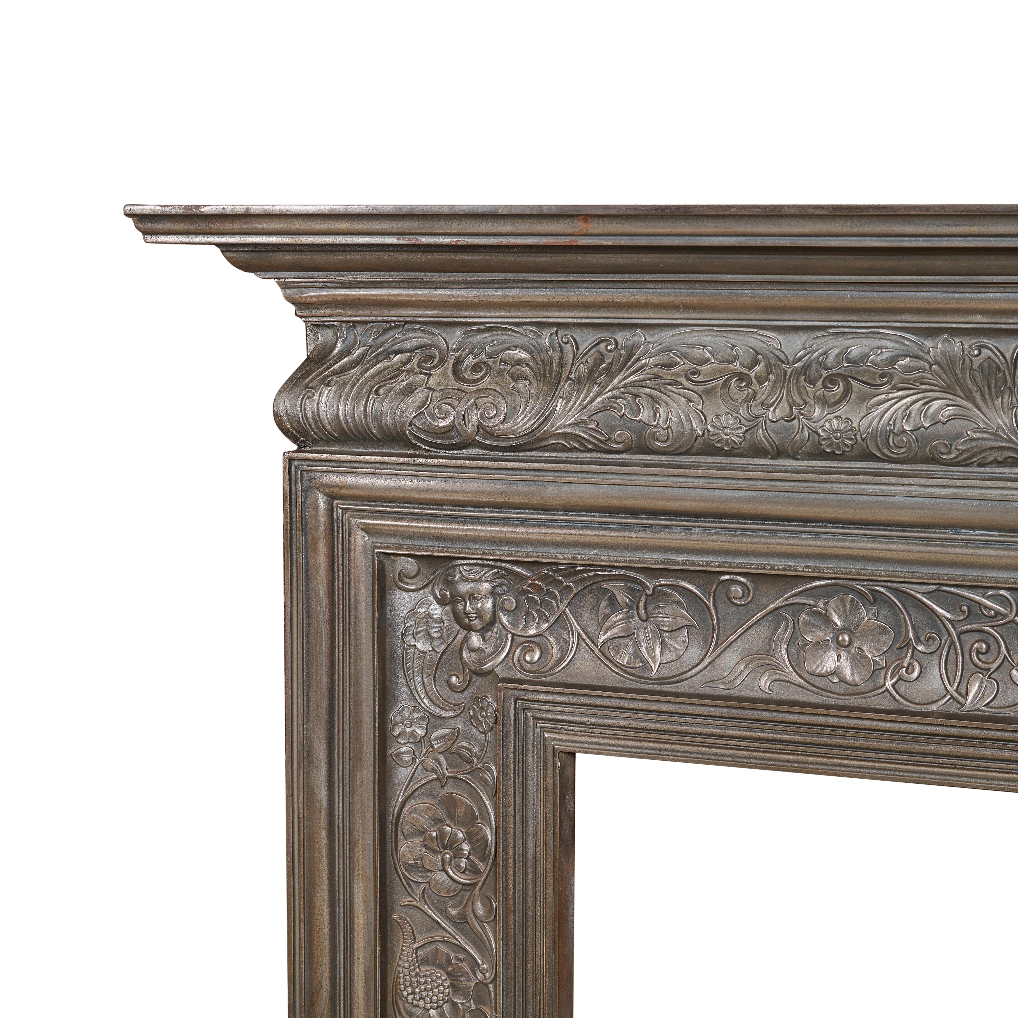 Polished cast iron fireplace surround. Great design by Coalbrookdale with cherub heads and earns. Amazing casting.
