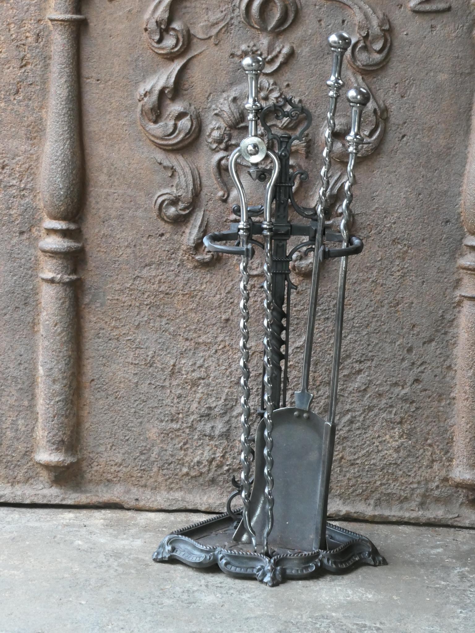 Beautifully decorated 19th century English Victorian fireplace tools. The tool set consists of thongs, shovel, poker and stand. The stand is made of cast iron and the tools are made from polished steel. The set has one minor loss but is otherwise
