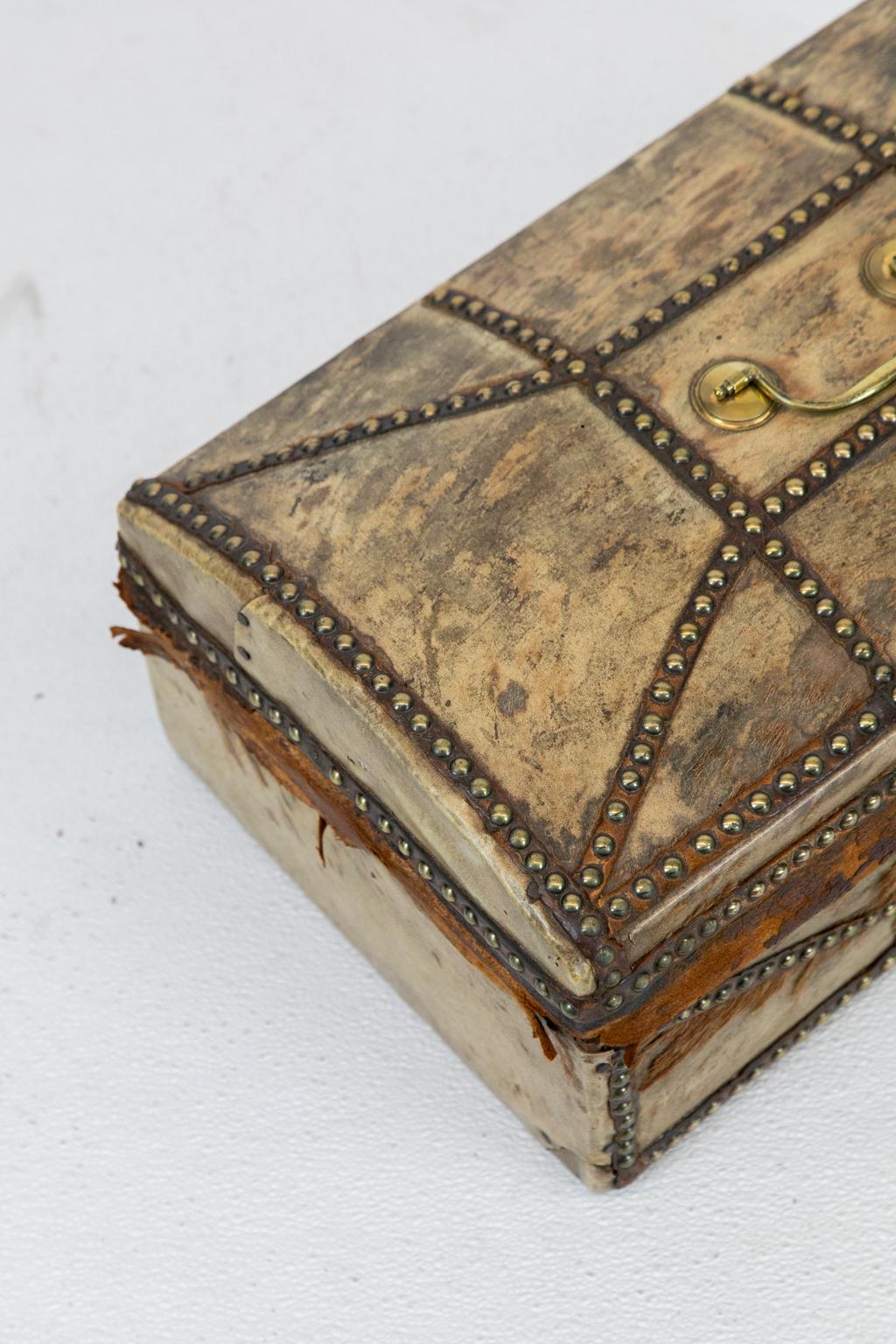 English Pony Skin Trunk, with brass stud decoration, retains its original paper lining, wear to the interior (see photos).