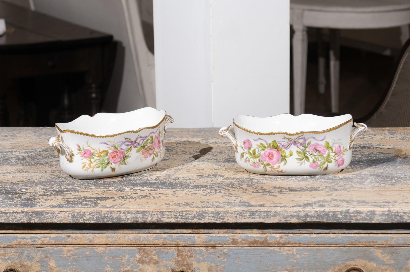 Two English porcelain bowls from the 20th century, with ribbon-tied pink roses and gilt accents, priced and sold individually. Charming our eyes with their graceful lines and delicate décor, each of these two English bowls is adorned with