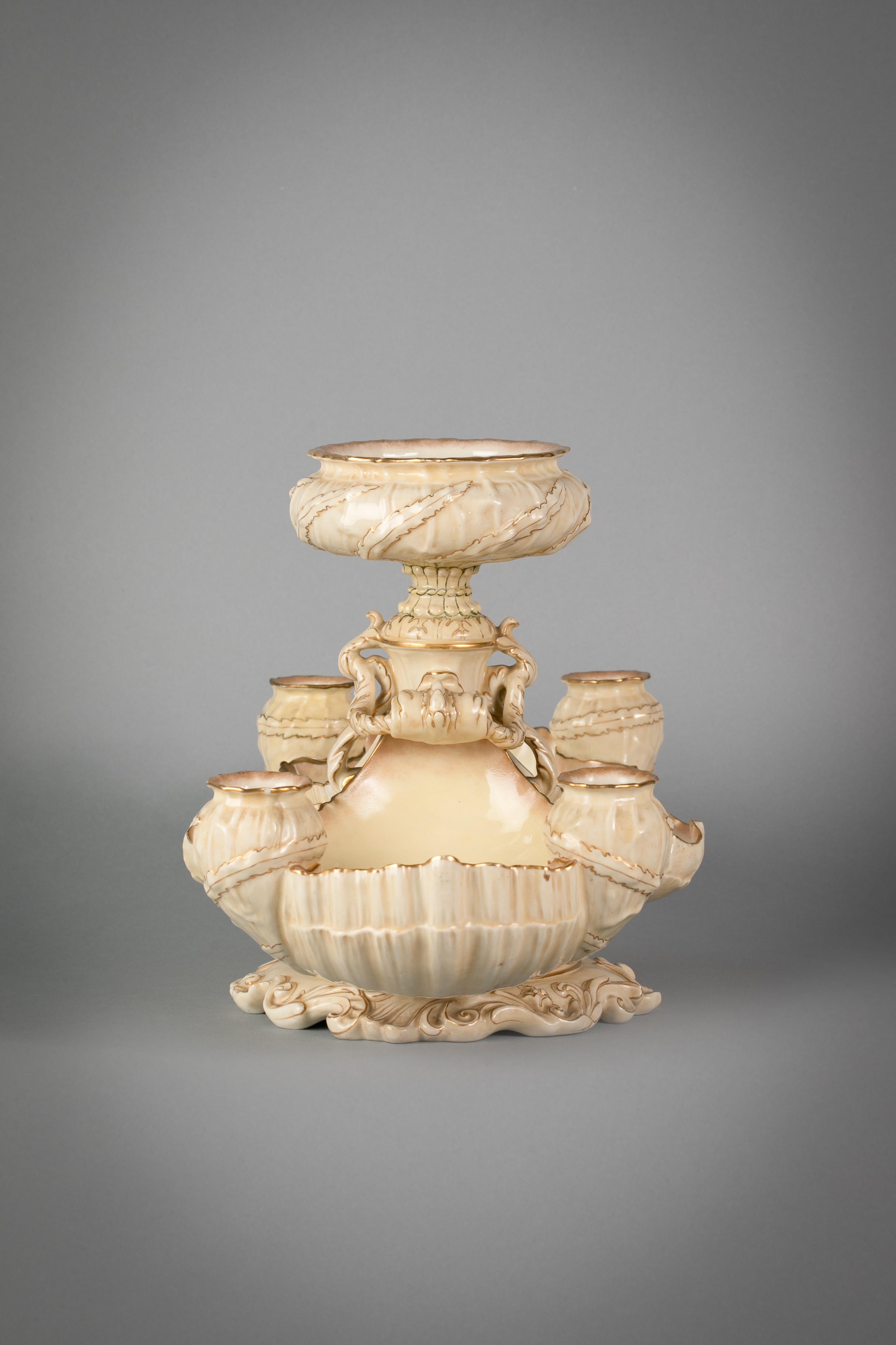 With two pairs of shell-form coupes and four candle holders with a central circular bowl. Marked Doulton Burslem.