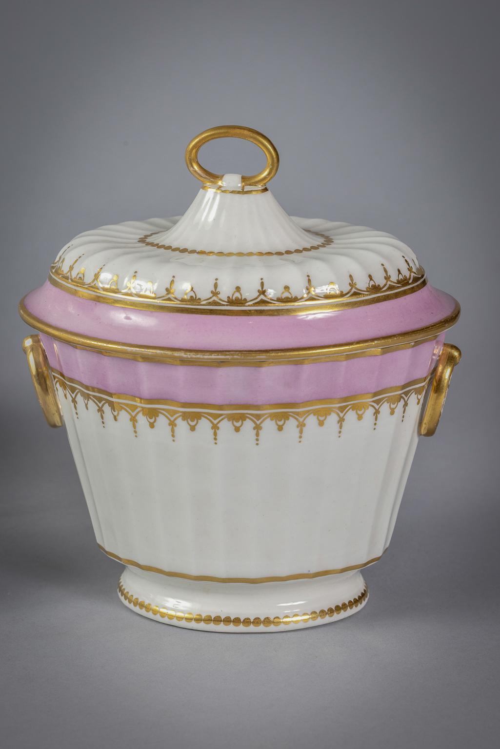 Comprising of teapot, sugar bowl and similar sugar bowl and cover. Cross batons and D mark, pattern number 574. With ring finials, the pink border between gilt lines and with gilt pendant scrolls.