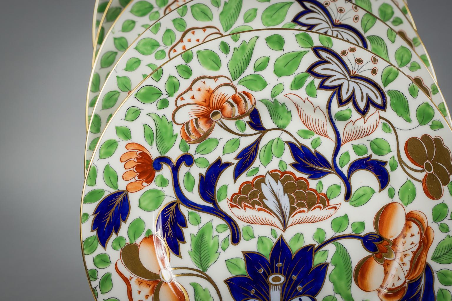 Chacune est décorée de motifs feuillus cobalt, vert lime, marron et corail sur fond blanc. Comprenant 12 assiettes à dîner, 12 assiettes à déjeuner (une telle quelle), 12 assiettes à pain et à beurre, 12 tasses et soucoupes.