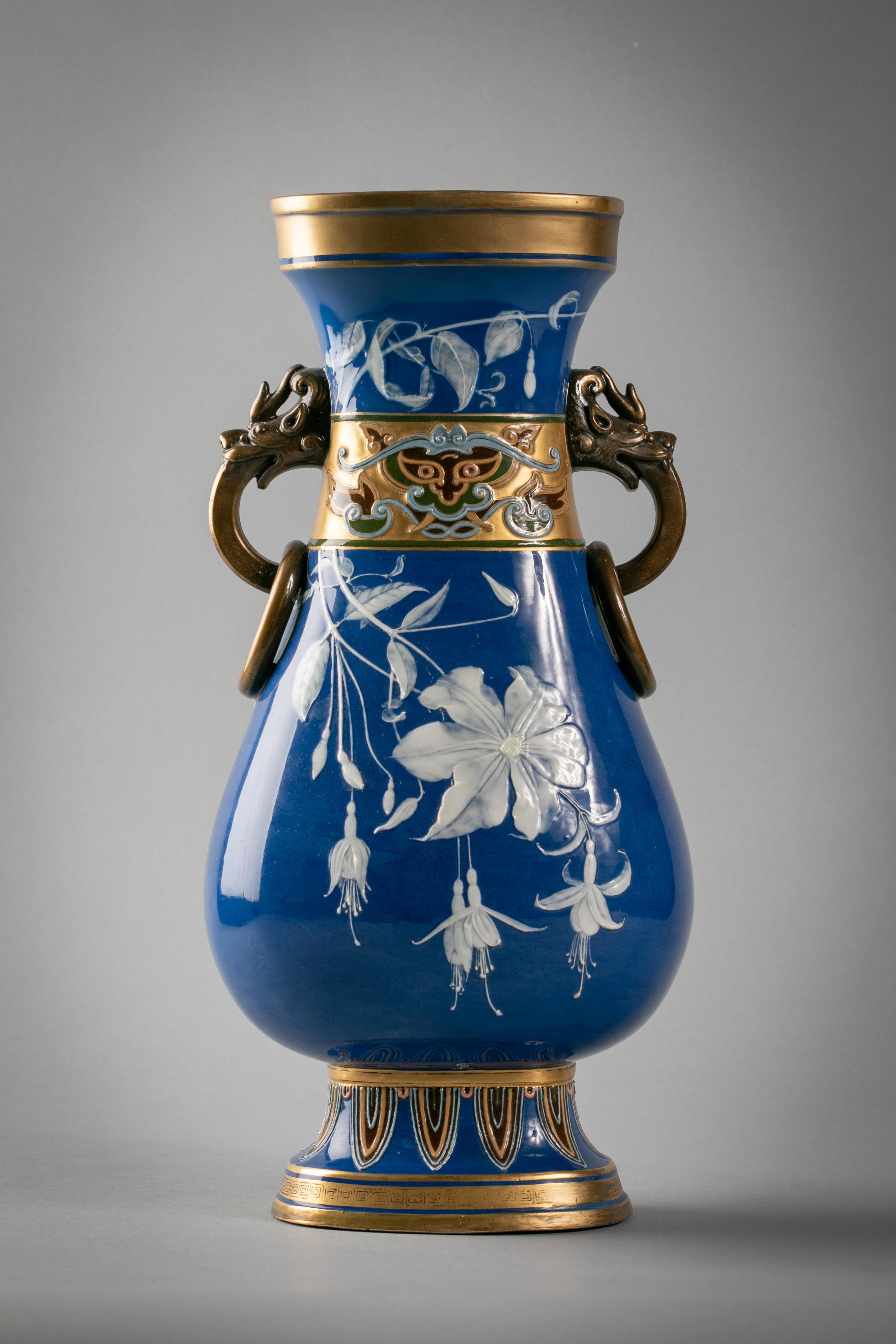 With dragon head and ringed handles flanking a band of Chinese archaic masks motifs. Impressed Minton, signed Frederick Rhead (1856-1933).