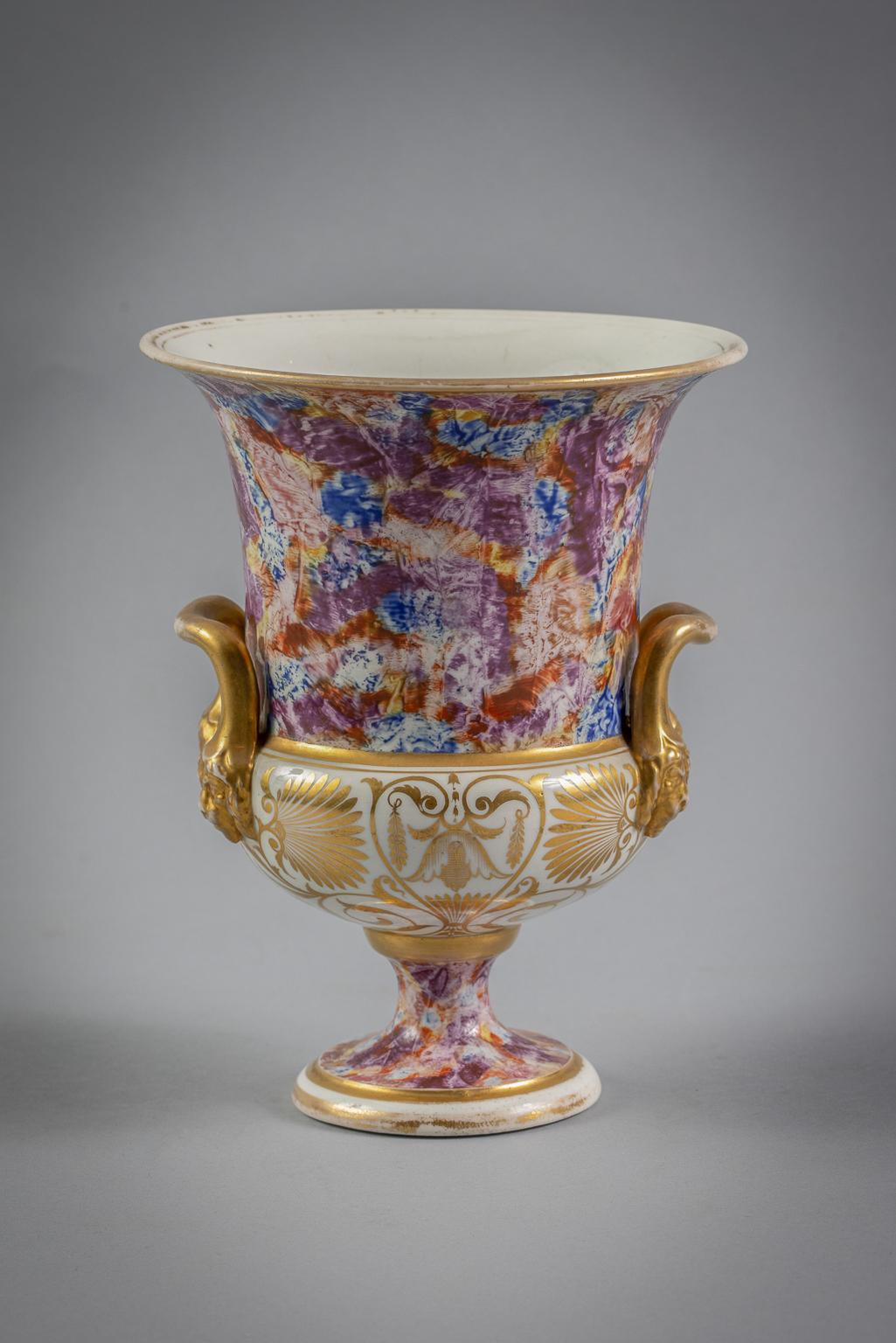 With lion-masked handles, marbleized decoration and with floral spray in the cartouche.