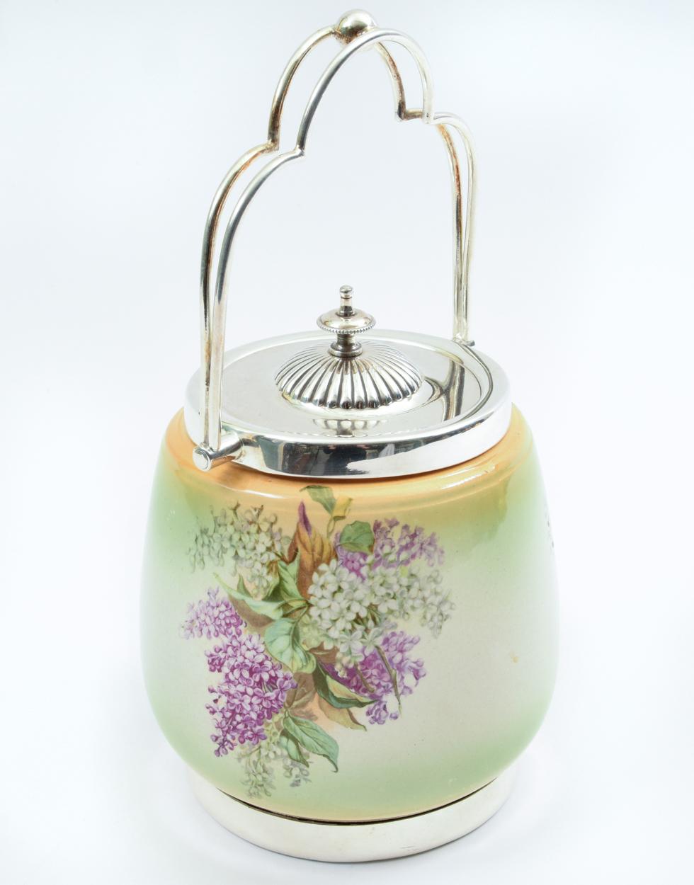 Antique English porcelain with silver plate covered ice with exterior floral design details. The ice bucket is in excellent antique condition. The ice bucket measure about 10 inches to the handle x 6 inches body diameter.