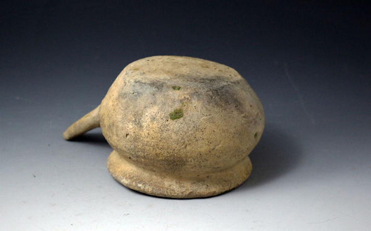 A rare post-medieval period earthenware cooking pot with a slightly incomplete handle. The rim has the hint of a pouring spout. The whitish pottery body and the green glaze to the interior lead to a Borderware attribution England.


Provenance: