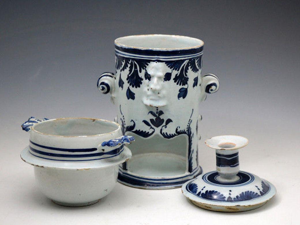 A rare mid-18th century London delftware food warmer with basin and candleholder. 
Apart from its functionality the piece is decorative with it mask heads and imposing handles. 

Dimensions: 6.00 inch wide, 10.50 inch high, 6.00 inch