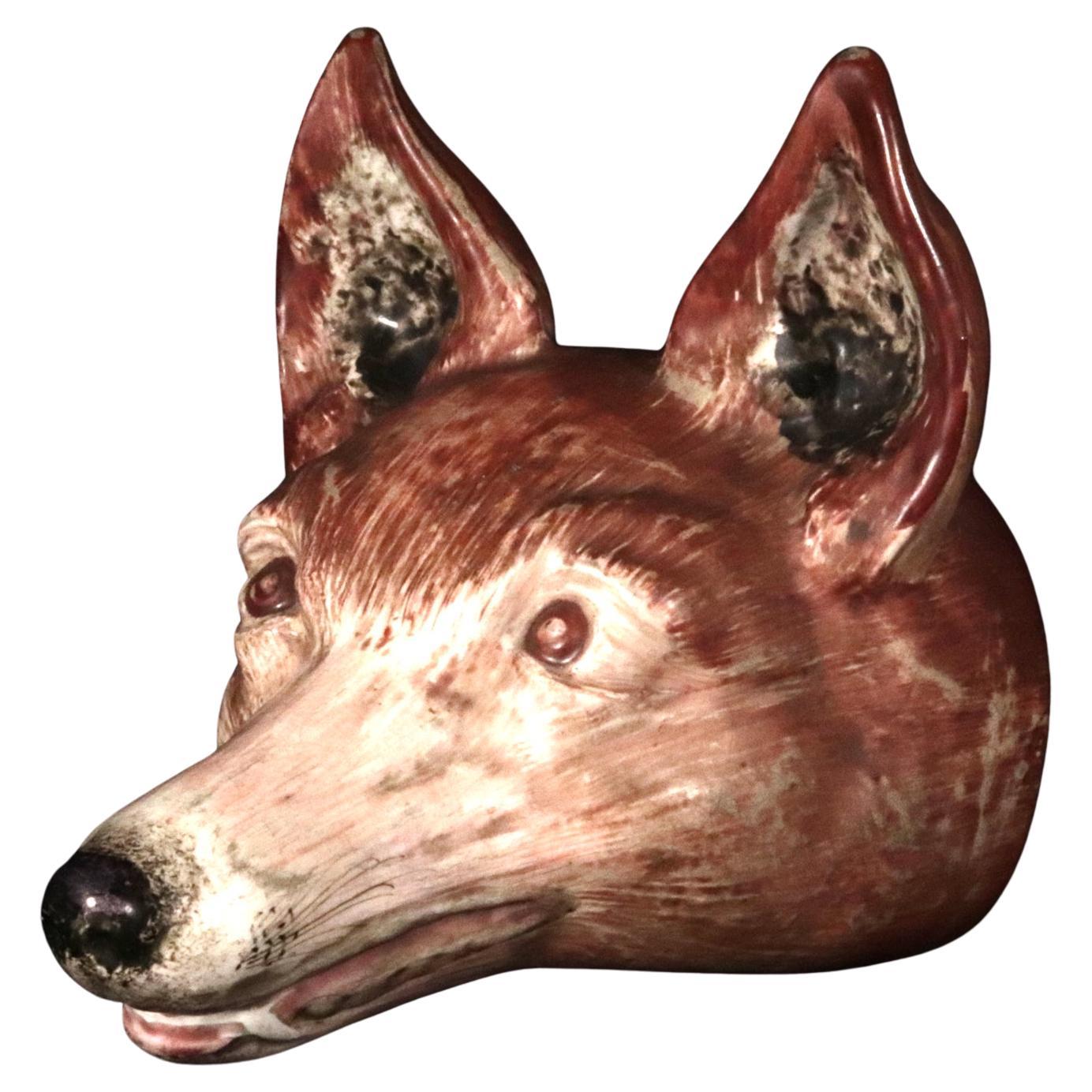 Fox-head Stirrup Cup,
Pearlware,
English,
Early 19th Century.

The large attractive pearlware stirrup cup is modeled as the head of a fox with ears pricked in naturalistic colors. The ears are hollow on the interior.

Dimensions: 5 1/2 inches inches