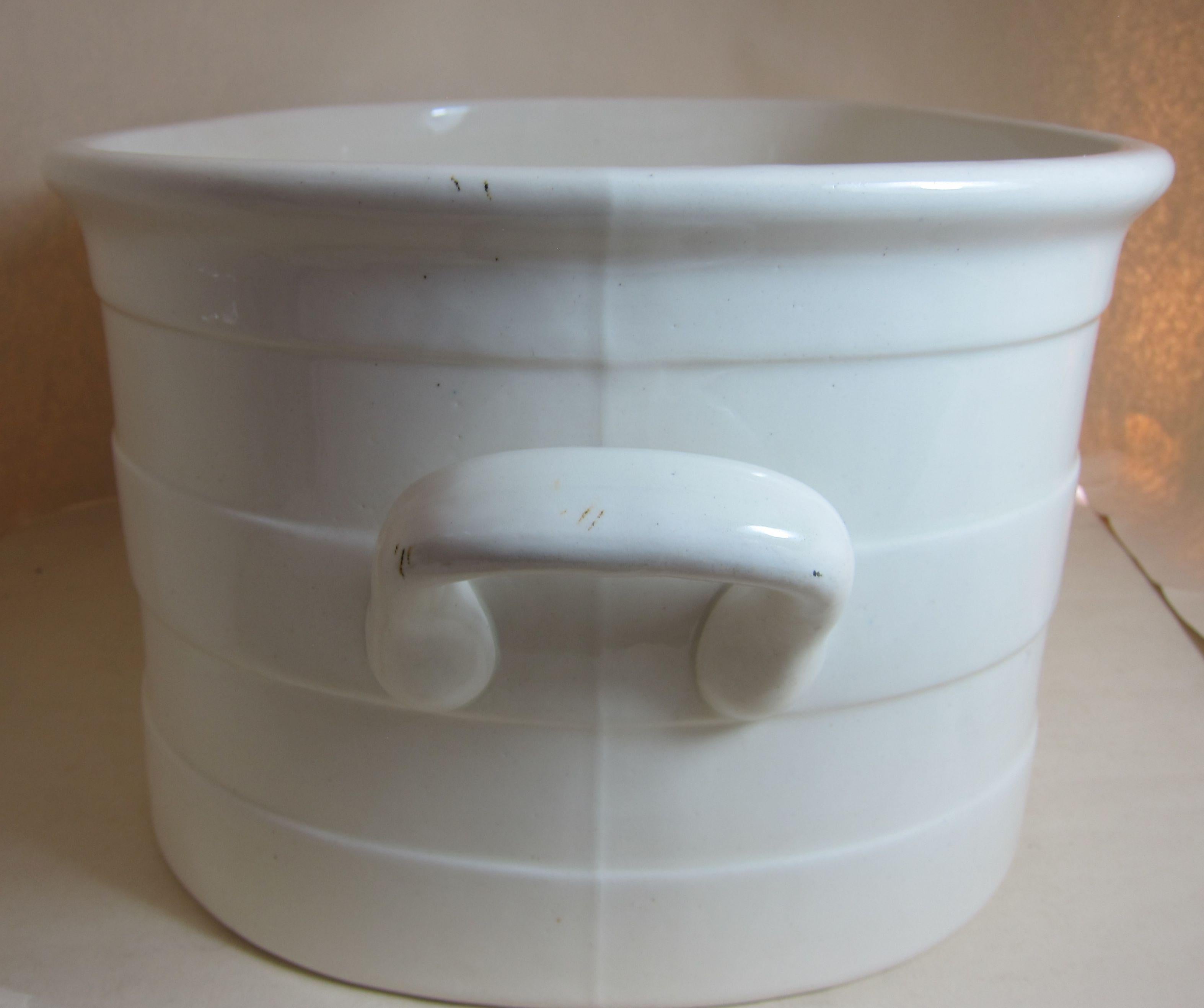 An English pottery white two handled footbath with strap bands. Footbaths days would have had a matching Jug and have been part of a bedroom toilet set. They make very good wine/champagne coolers and marvellous for plants.