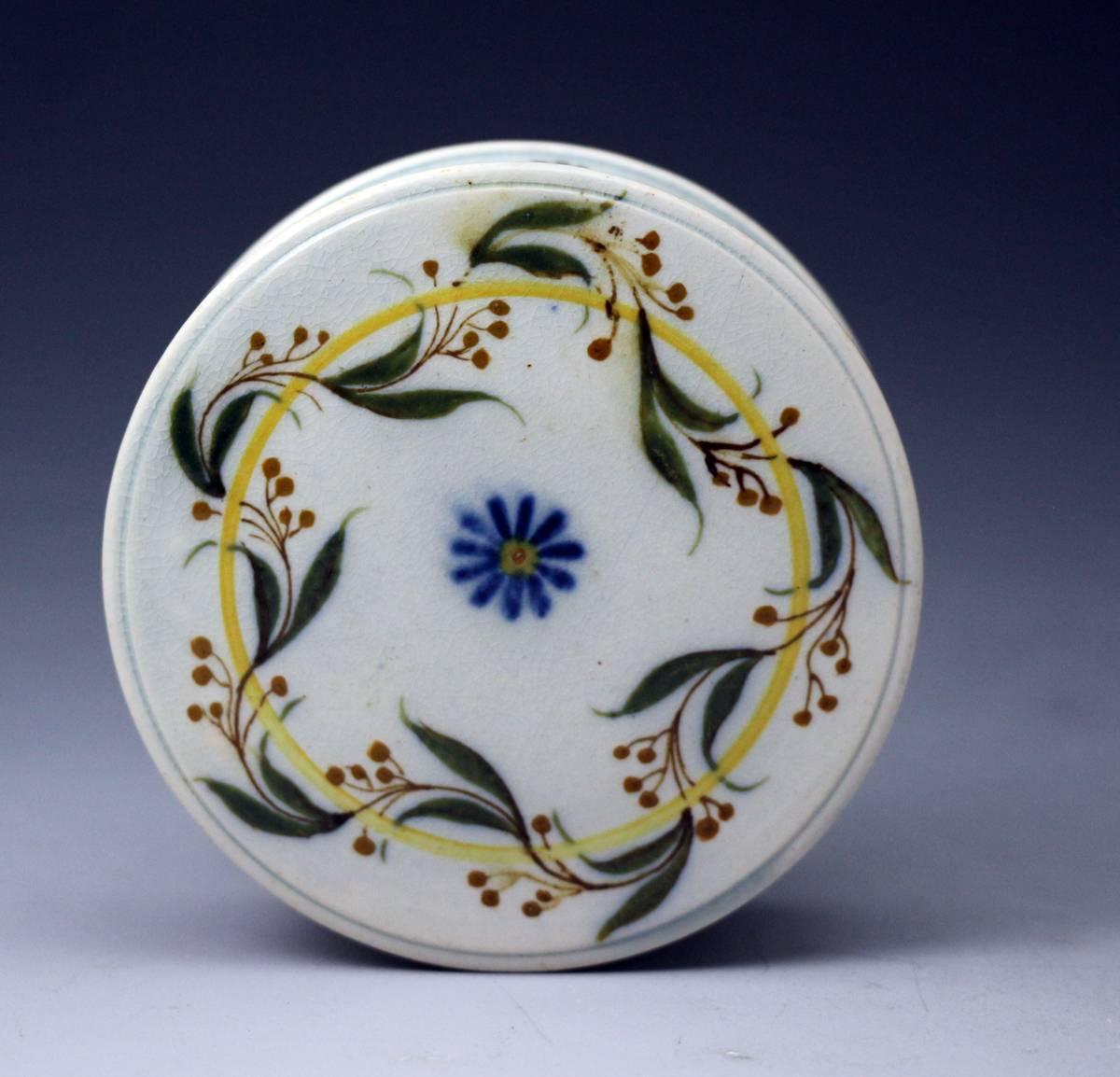 A very fine pottery circular patch box beautifully decorated in Pratt colours, underglaze oxides with a fine pearlware glaze. The cover screws onto the base and the piece is in very clean crisp condition. Probably Staffordshire early 19th century.