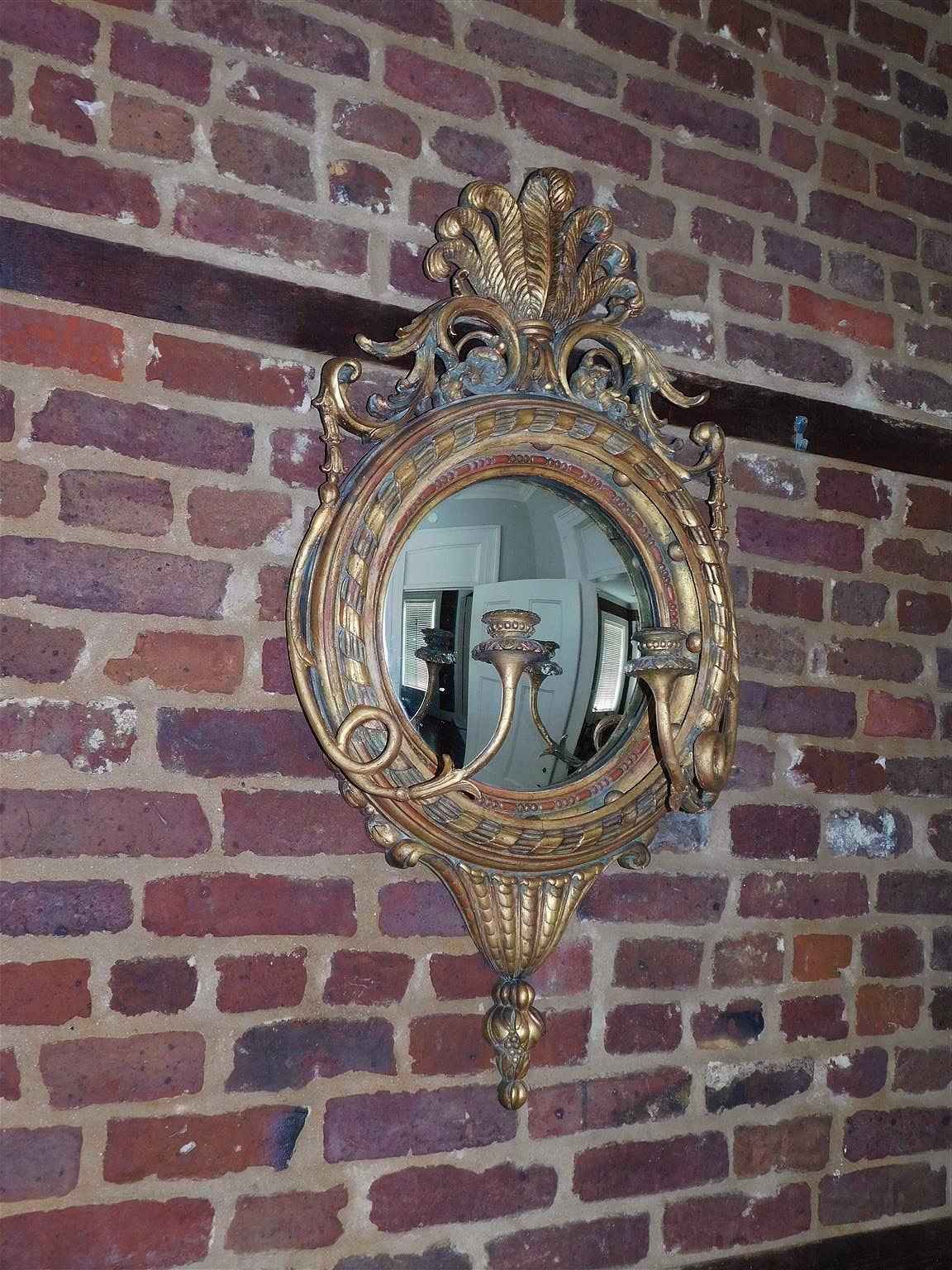 English Prince of Wales gilt wood and gesso acanthus foliage with flanking cascading bell flowers girandole convex wall mirror, Early 19th Century. 
Mirror retains the original silvered glass and wood backing. 