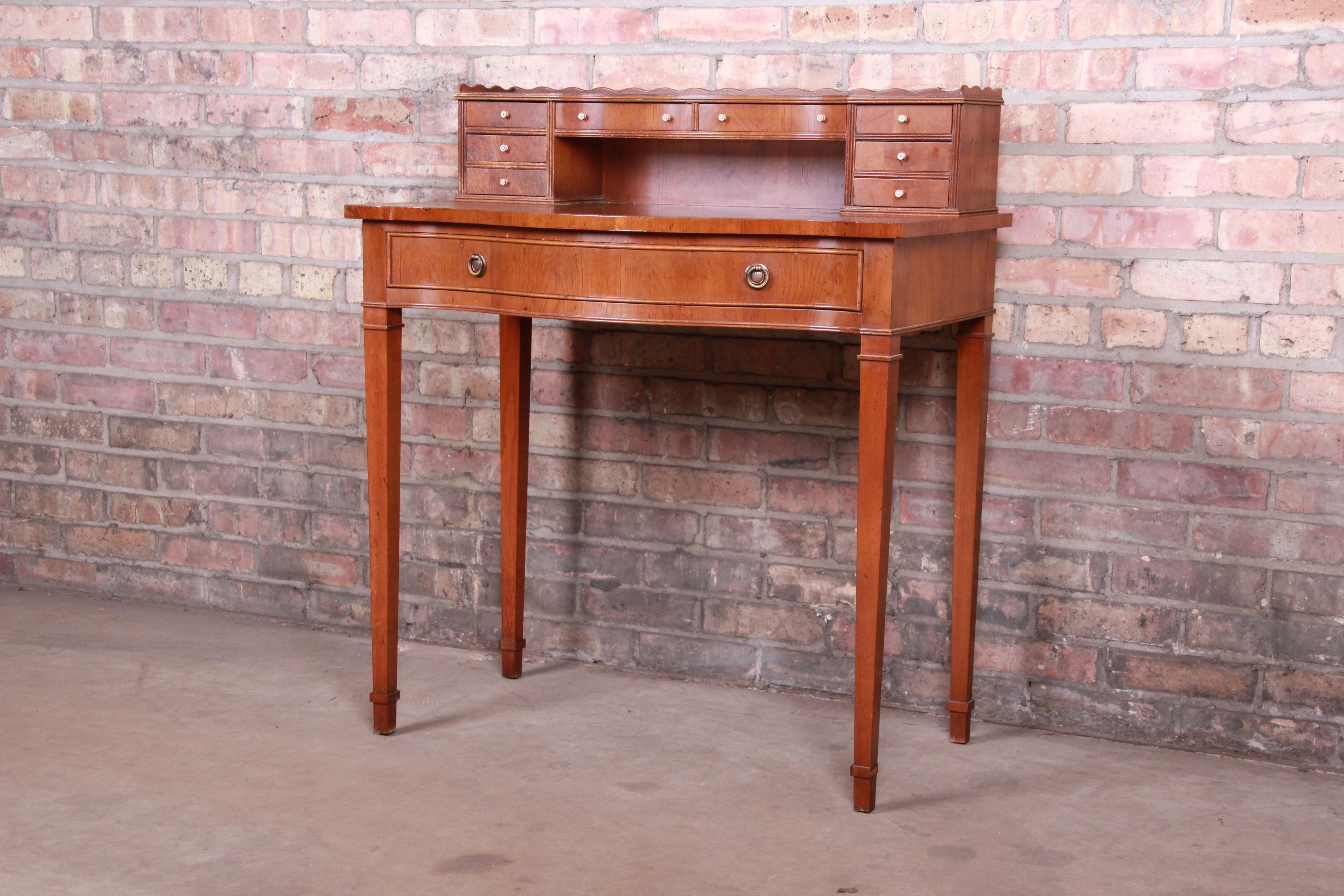 A gorgeous English Provincial style ladies writing desk

circa 1960s

Fruitwood, with tooled leather top writing surface.

Measures: 31.5