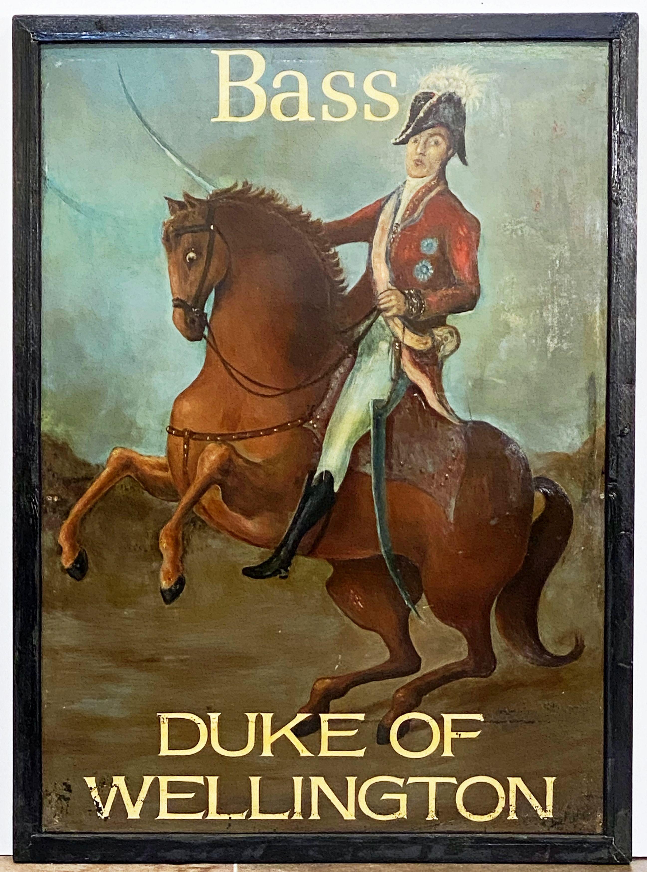 An authentic English pub sign (one-sided) featuring a painting of the famous Napoleonic-era British military hero with his sword drawn, upon a horse, entitled: Duke of Wellington and Bass (for Bass Brewery, the original pub license