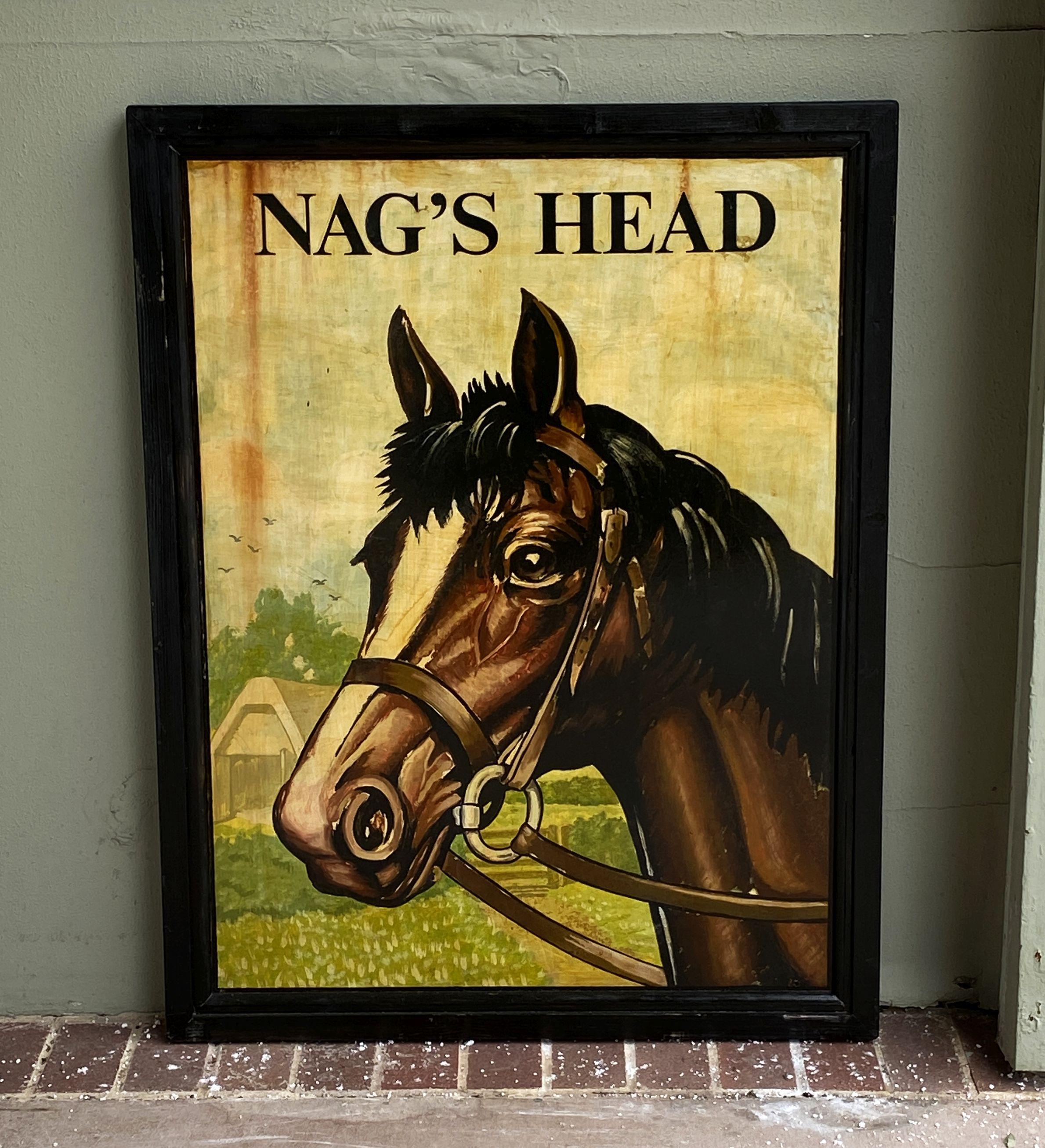 An authentic English pub sign (two-sided) featuring a painting of a horse's head in a bridle entitled: Nag's Head.

A very fine example of vintage advertising artwork, ready for display.

