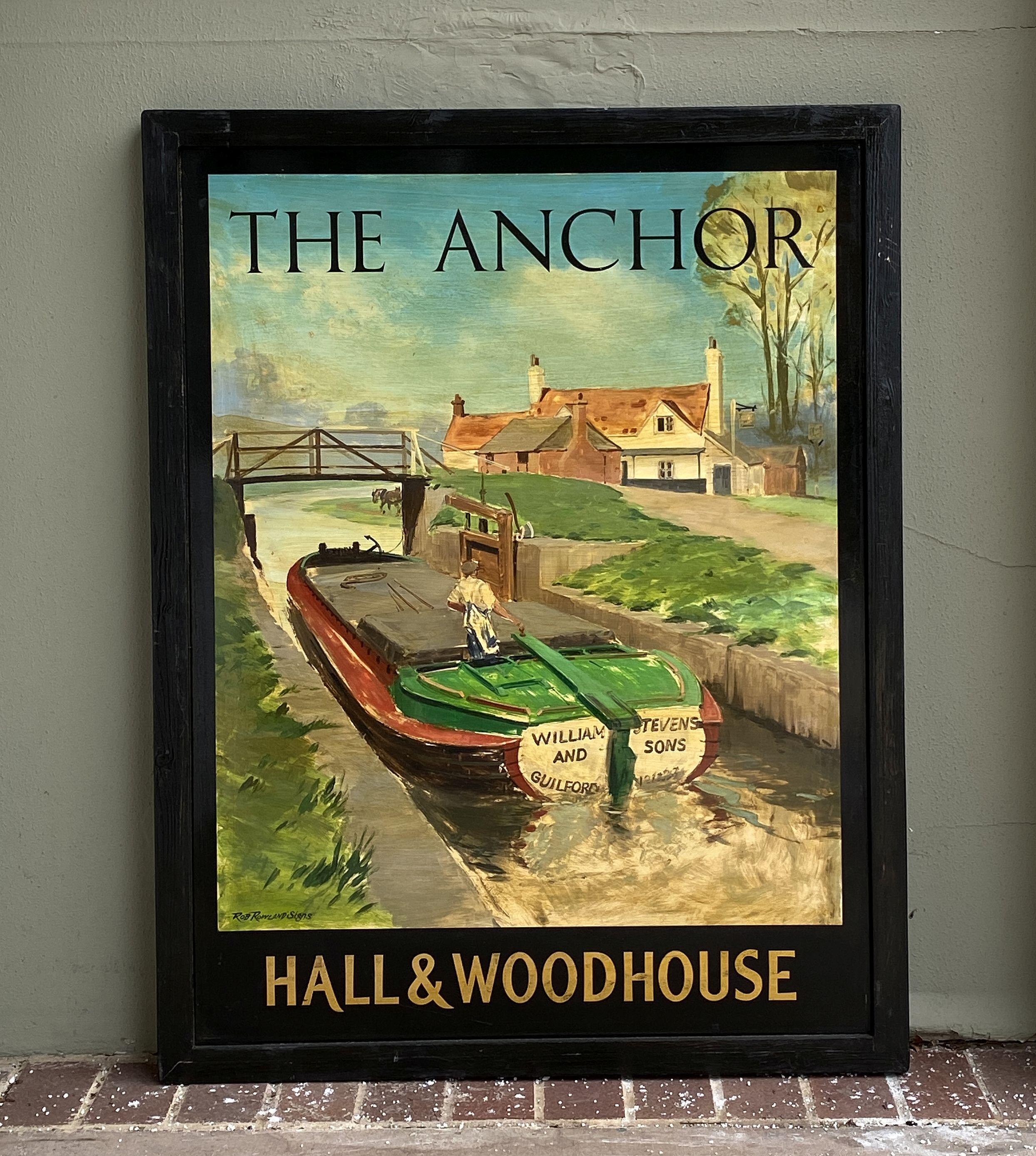 An authentic English pub sign (one-sided) featuring a painting of a barge navigating a canal, entitled: The Anchor - Hall & Woodhouse.

A very fine example of vintage advertising artwork, ready for display.

Hall and Woodhouse is a British regional