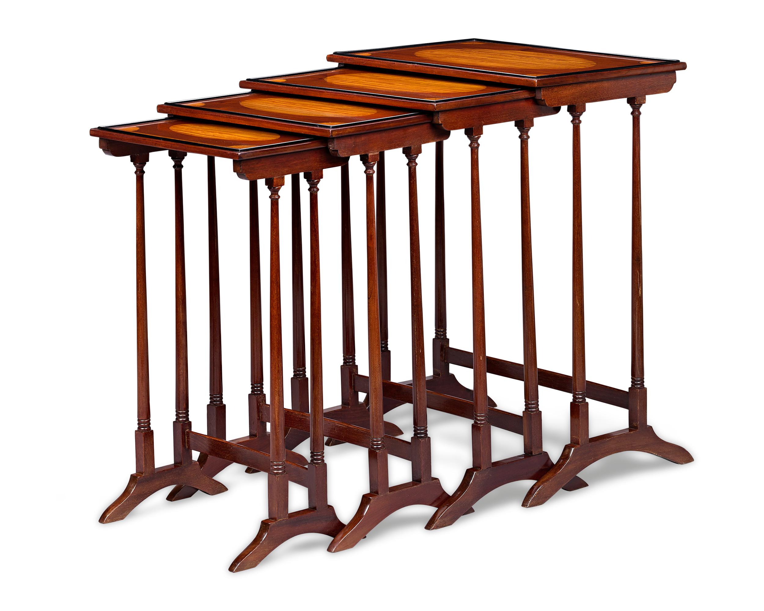 This suite of mahogany quartetto nesting tables displays the refinement found only in the finest English Victorian furnishings. Featuring beautiful satinwood marquetry on the tops, these tables would make a charming addition to any living space. In