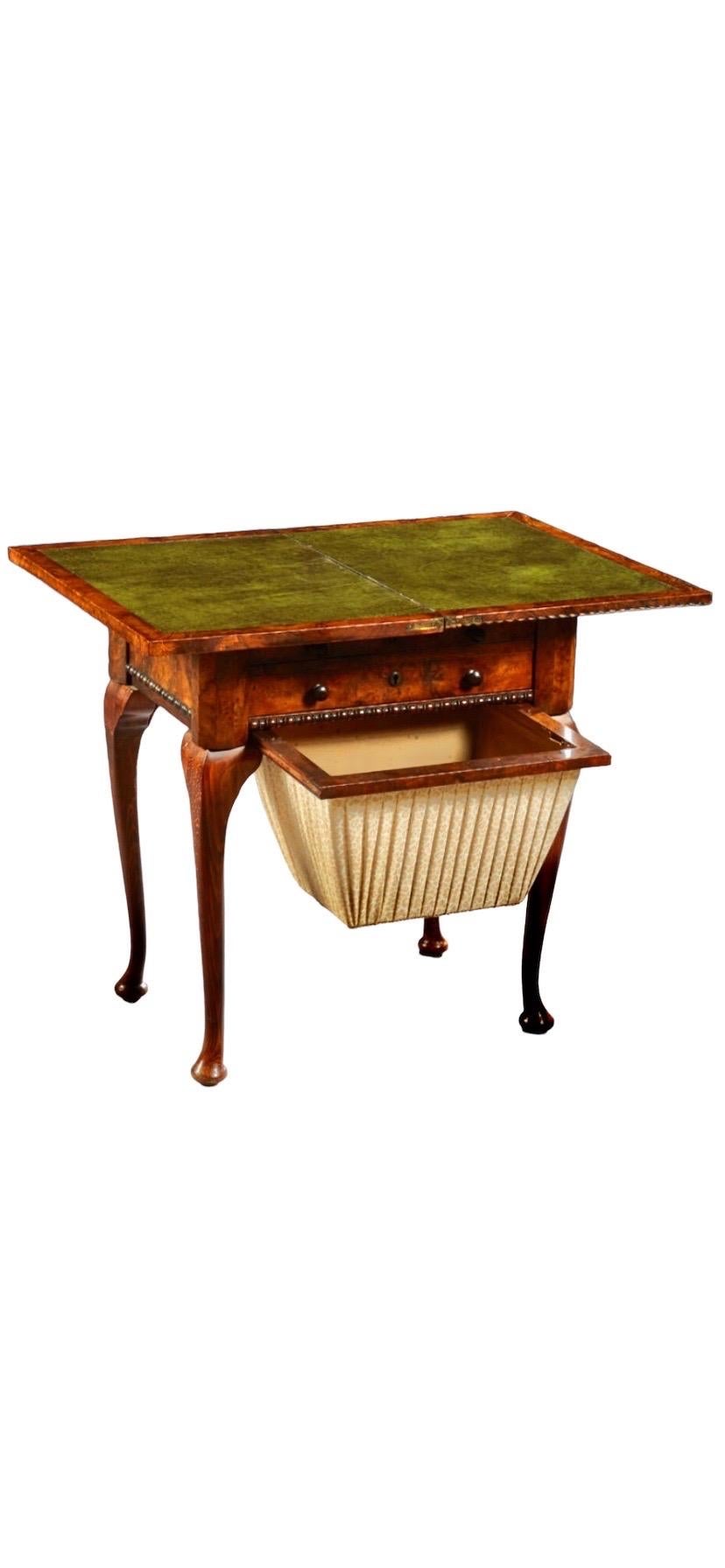 English Queen Anne Carved
Walnut Work/Games Table, 19th c.,
the gadrooned edge top opening to
a leather inset gaming surface over a pull
out backgammon board above a
compartmented sewing drawer above a inlaid chess/checkers board and
a bottom work