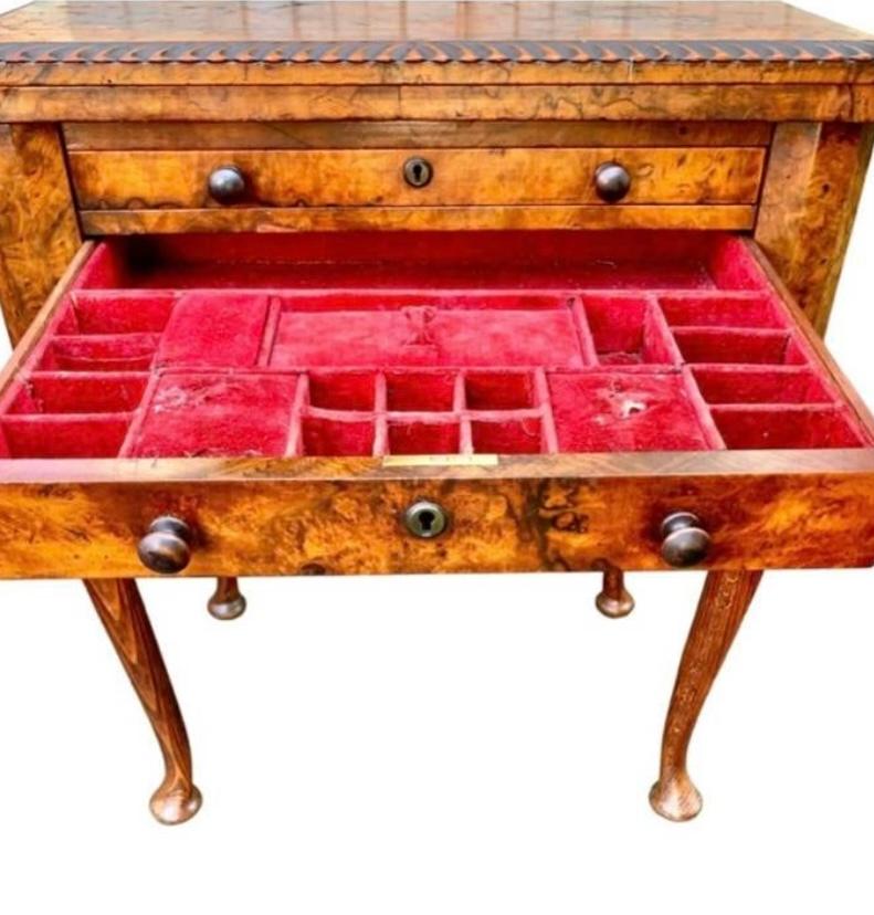 English Queen Anne Carved
Walnut Work/Games Table, 19th c.,
the gadrooned edge top opening to
a leather inset gaming surface over a pull
out backgammon board above a
compartmented sewing drawer above a inlaid chess/checkers board and
a bottom work