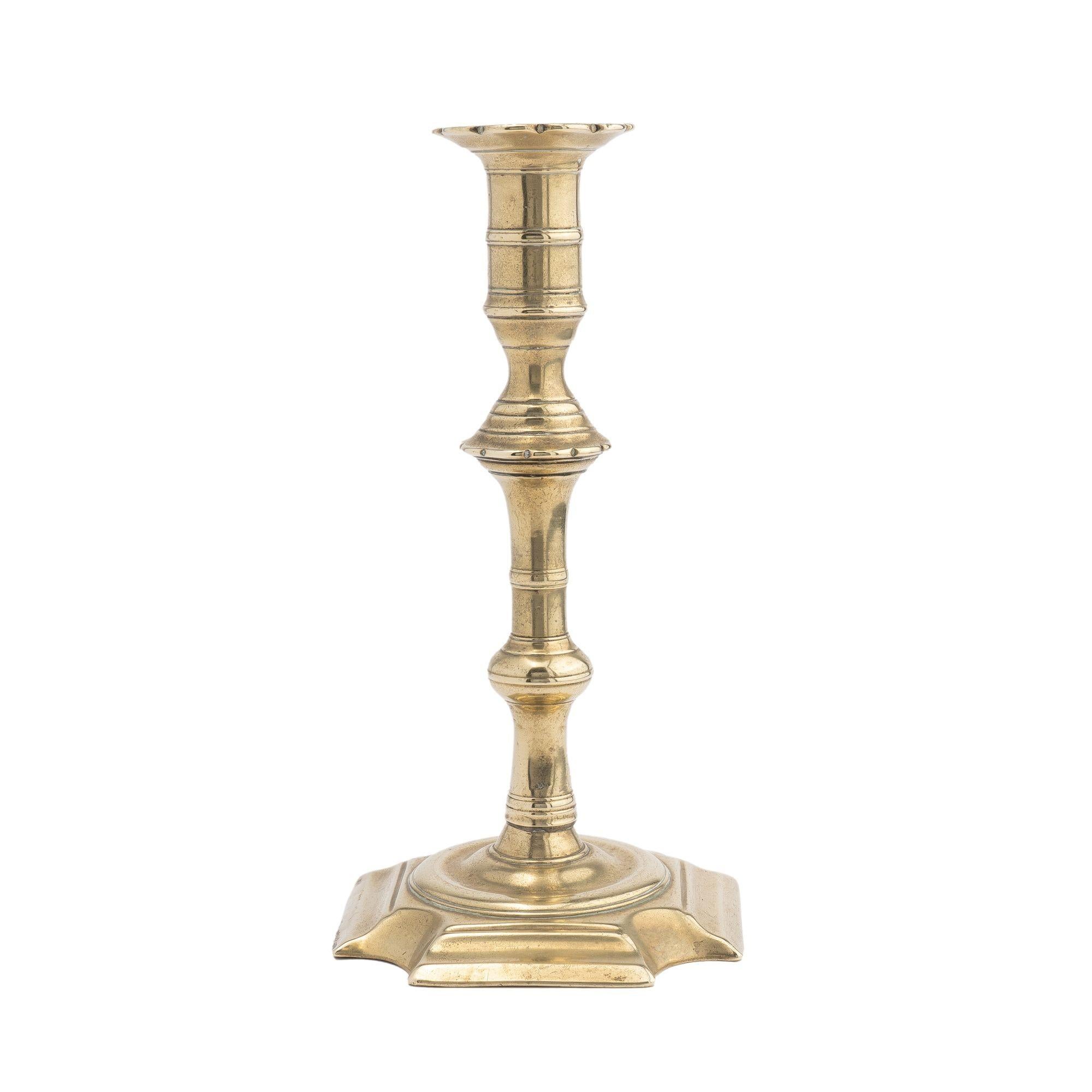 British English Queen Anne cast brass cove cut corner base candlestick, 1725-50 For Sale