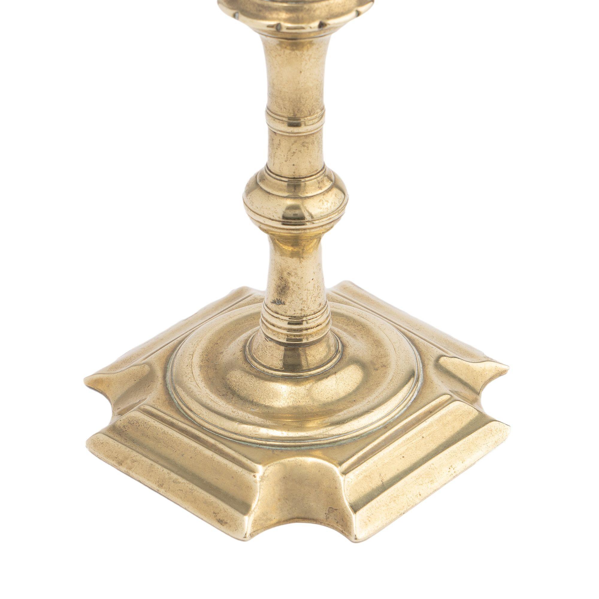 18th Century English Queen Anne cast brass cove cut corner base candlestick, 1725-50 For Sale