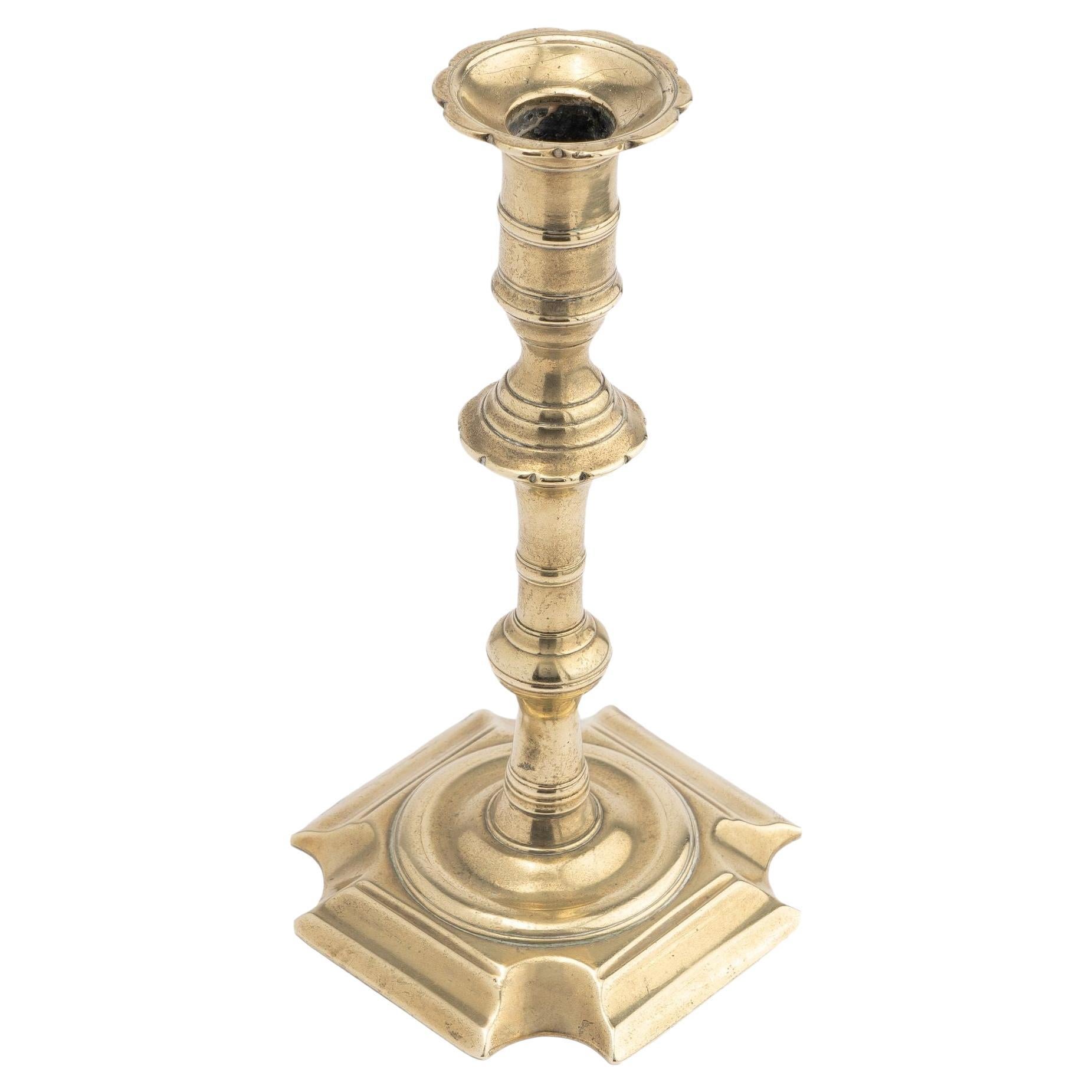 English Queen Anne cast brass cove cut corner base candlestick, 1725-50 For Sale