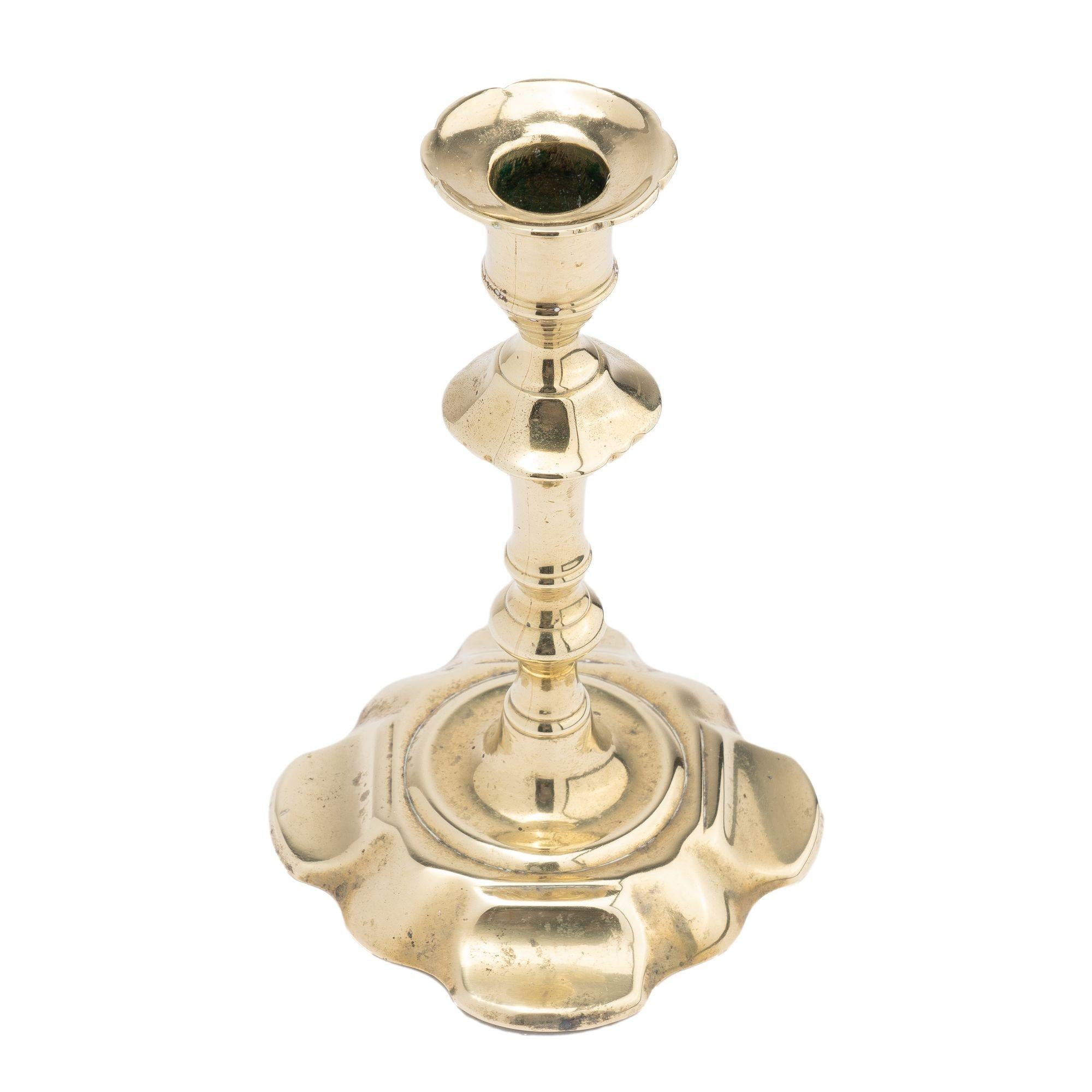 British English Queen Anne cast brass petal base candlestick, 1750-60 For Sale